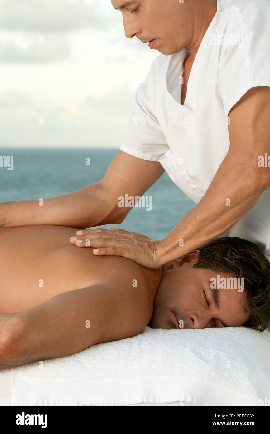 A woman giving a man shoulder massage Stock Photo - Alamy