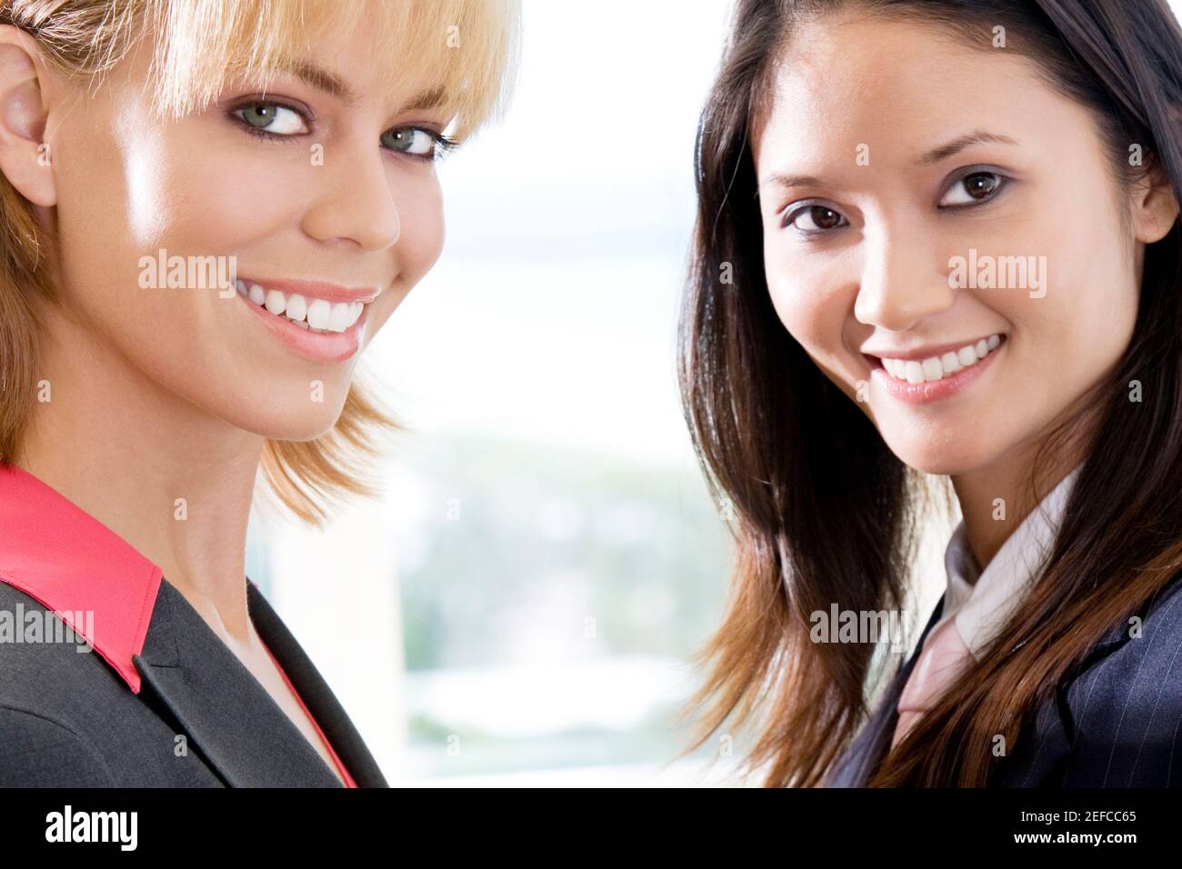 Portrait of two businesswomen smiling Stock Photo - Alamy