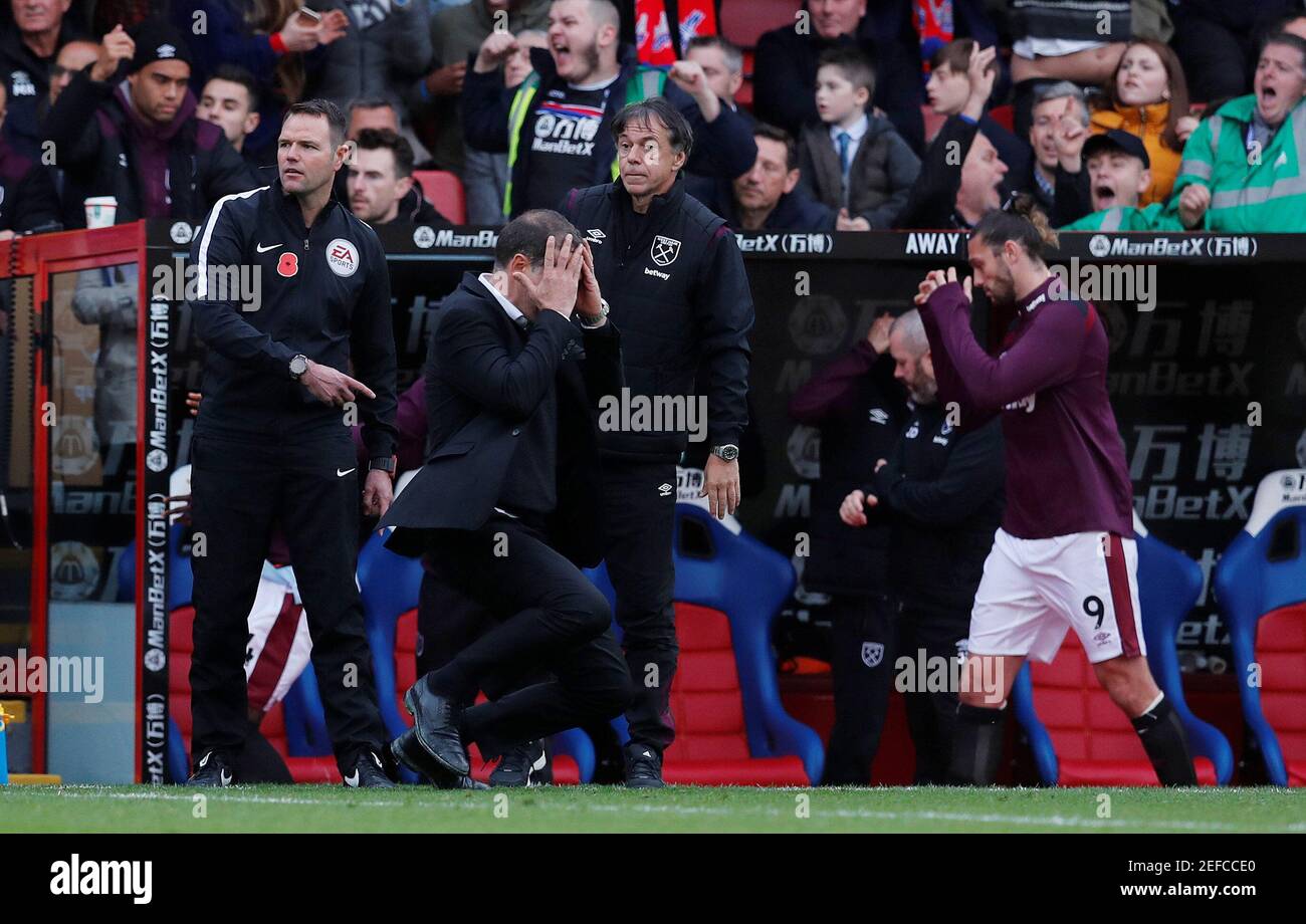 Soccer Football - Premier League - Crystal Palace vs West Ham United - Selhurst Park, London, Britain - October 28, 2017   West Ham United manager Slaven Bilic looks dejected as Crystal Palace celebrate their second goal   REUTERS/Eddie Keogh    EDITORIAL USE ONLY. No use with unauthorized audio, video, data, fixture lists, club/league logos or 'live' services. Online in-match use limited to 75 images, no video emulation. No use in betting, games or single club/league/player publications. Please contact your account representative for further details.? Stock Photo