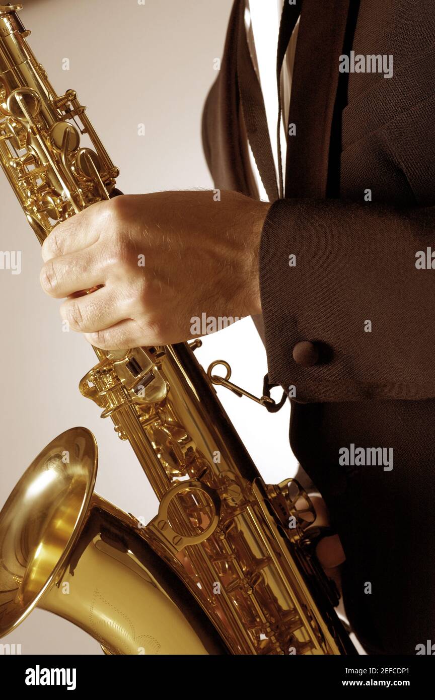 Mid section view of a musician playing the saxophone Stock Photo Alamy