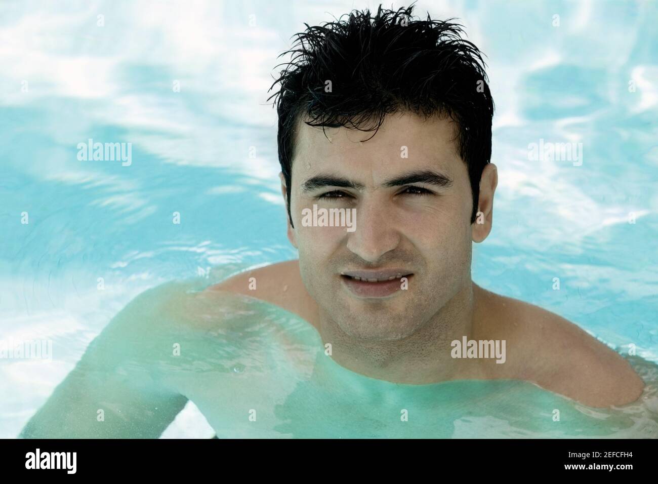 Portrait of a young man in a swimming pool Stock Photo - Alamy