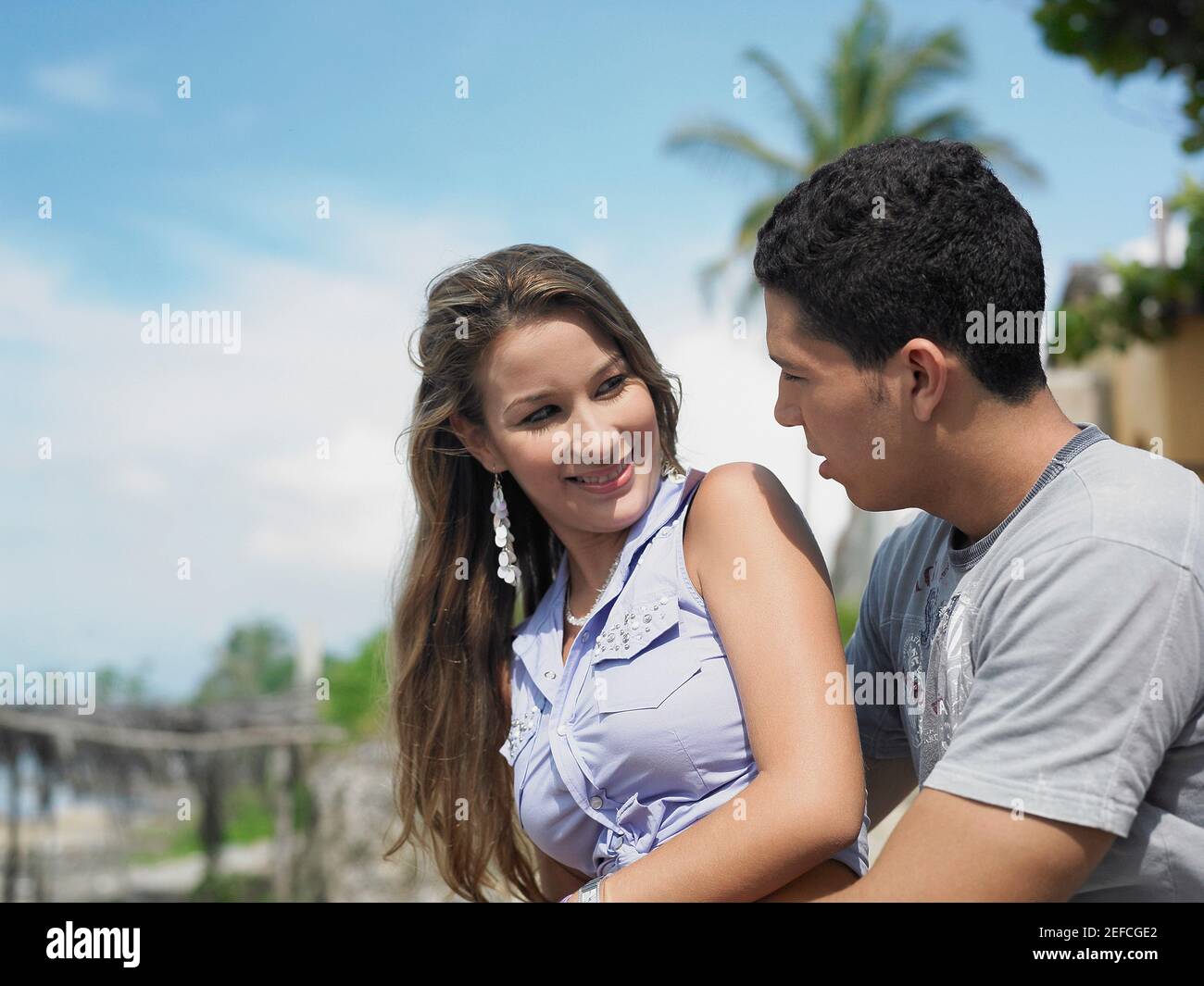 Side profile of a young man embracing a young woman from behind Stock ...
