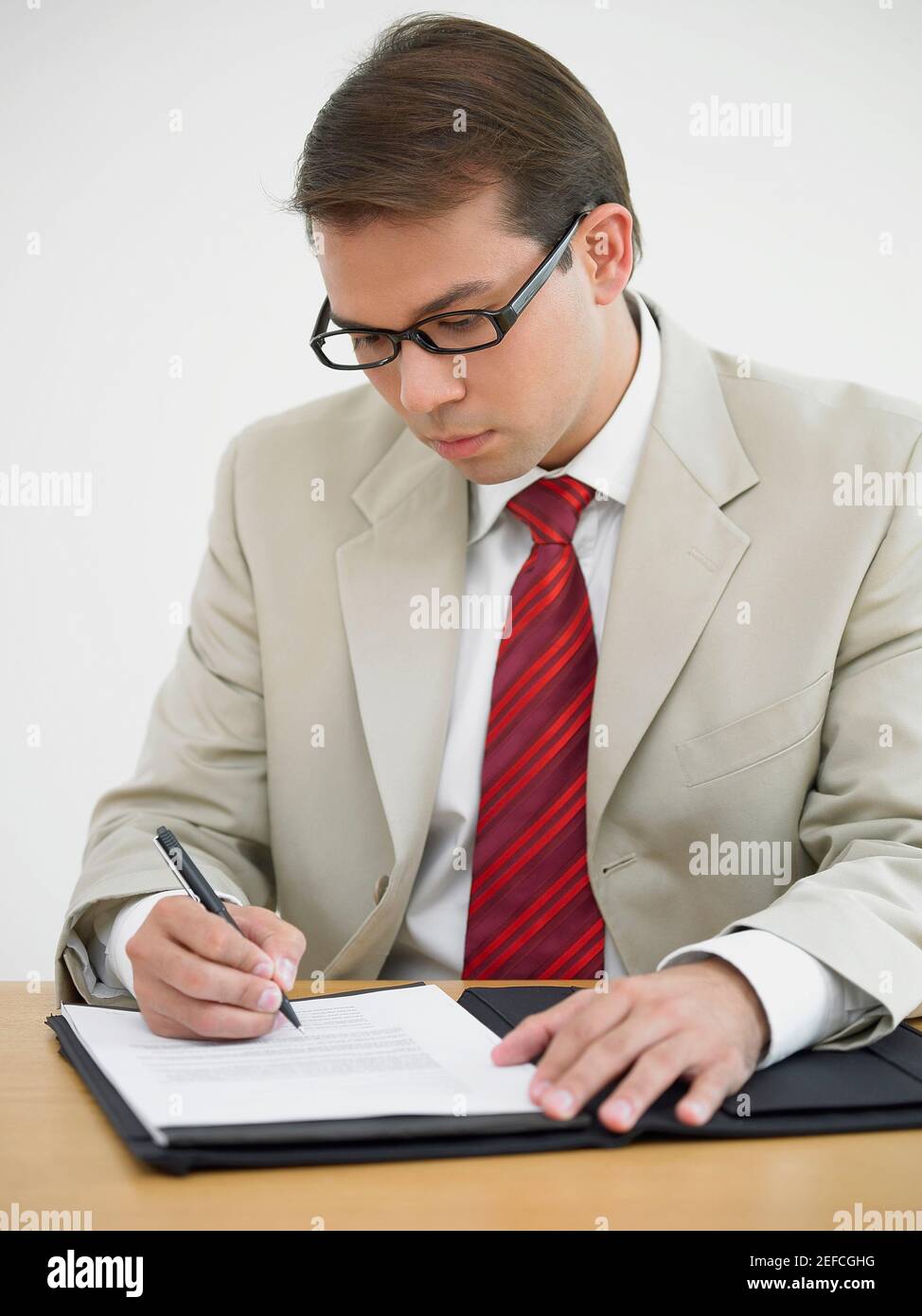 Businessman writing on a document Stock Photo
