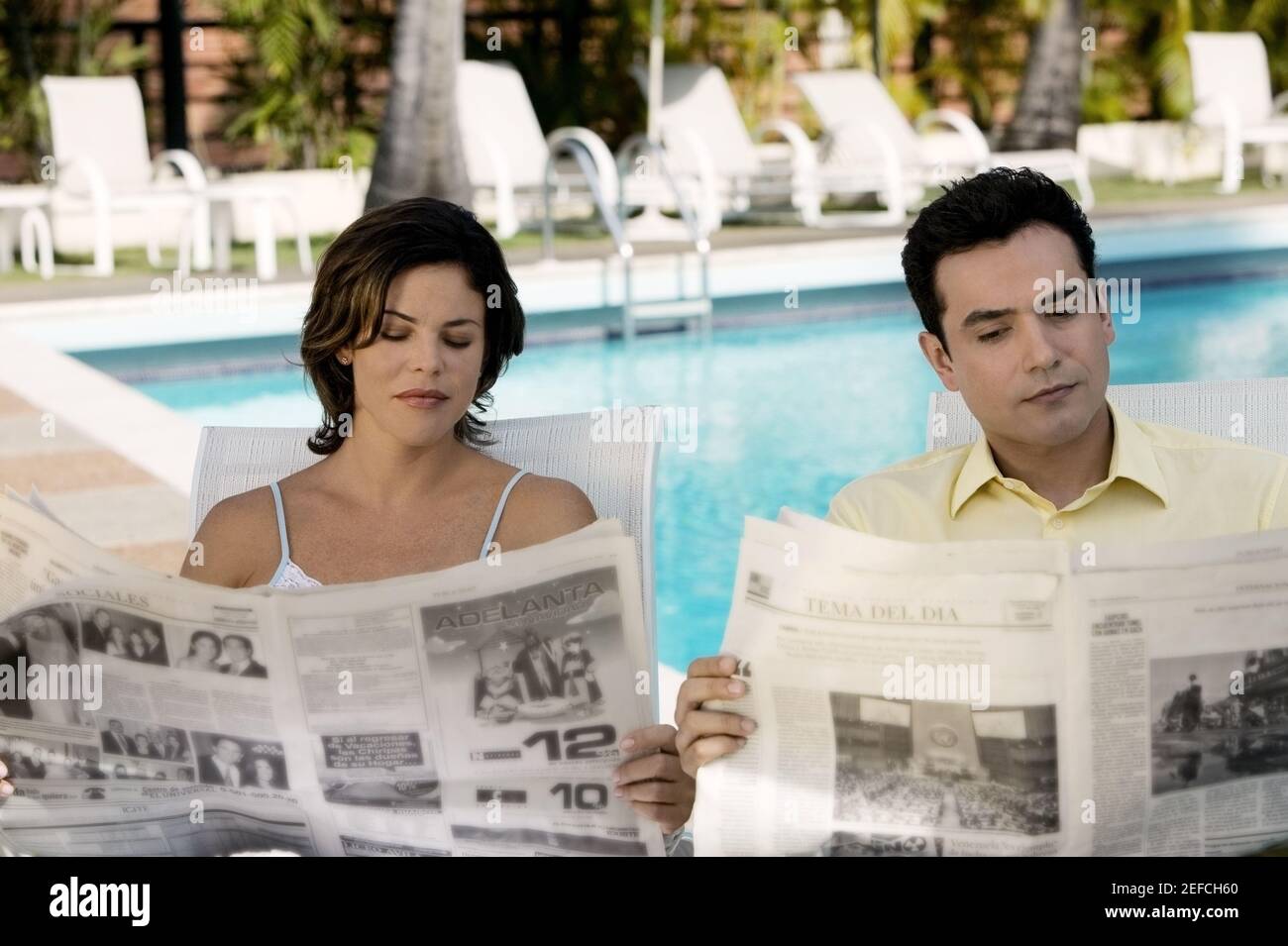 Young couple reading newspaper Stock Photo