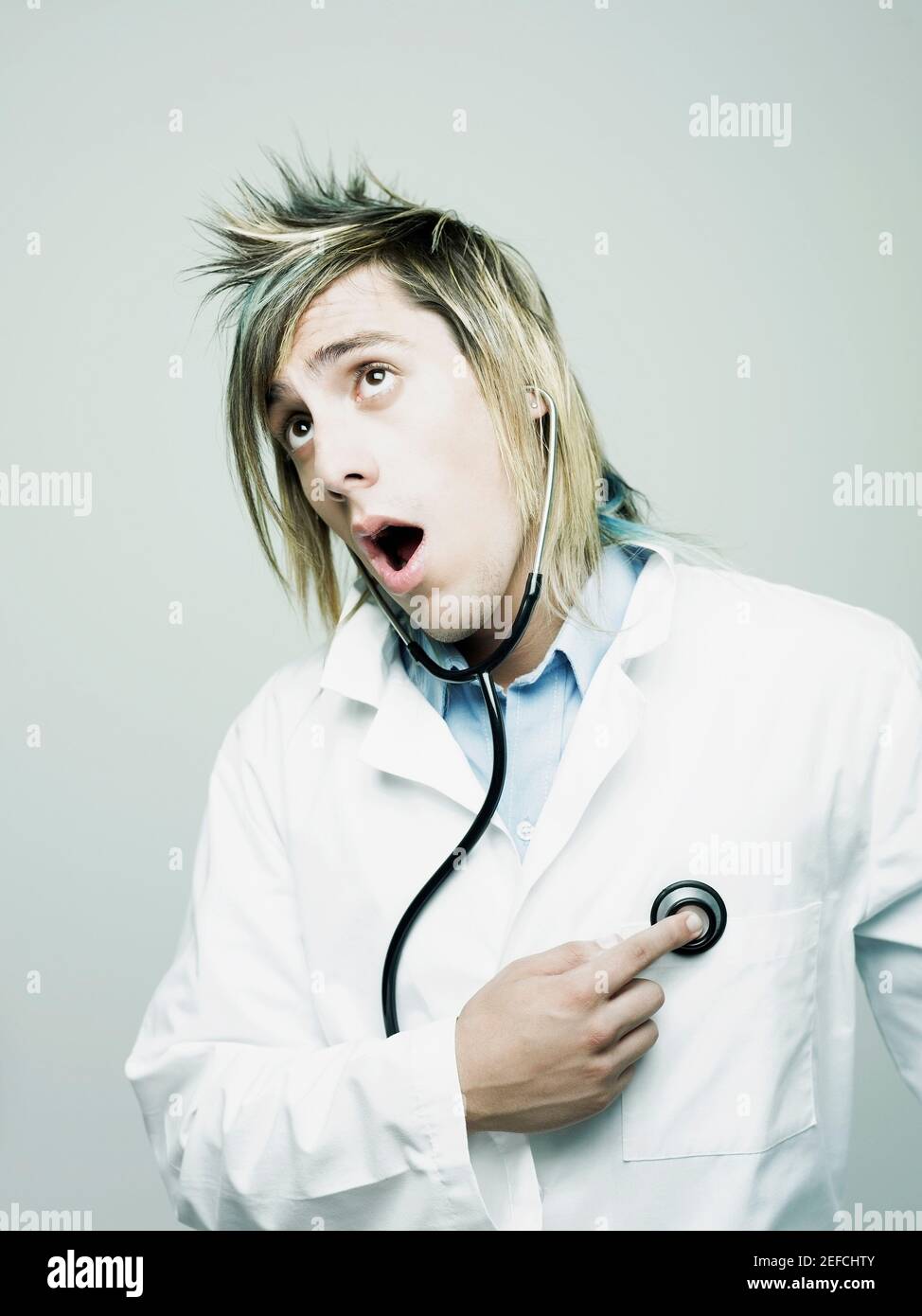 Close_up of a male doctor examining himself with a stethoscope Stock Photo