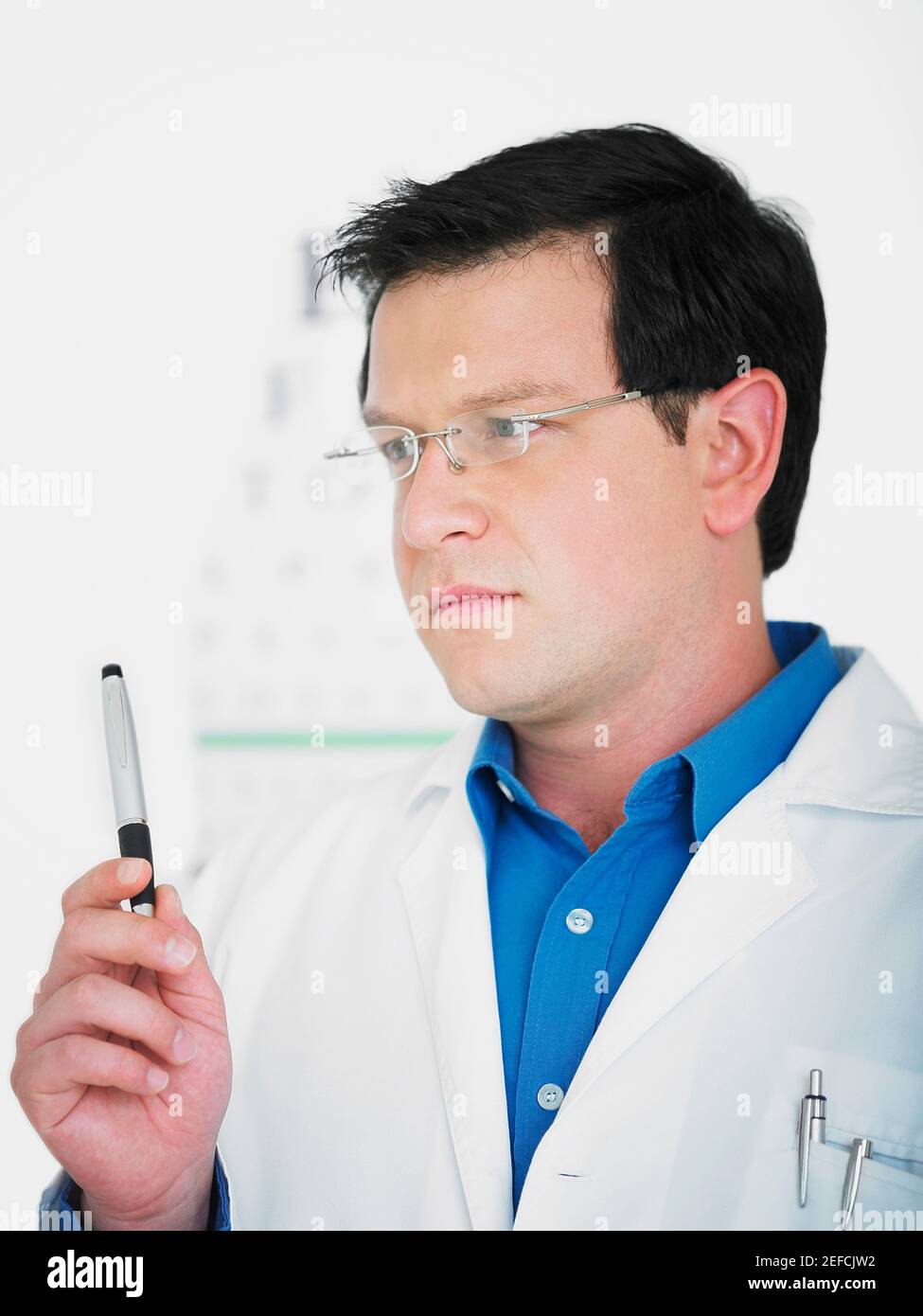 Close up of a male doctor holding a pen Stock Photo