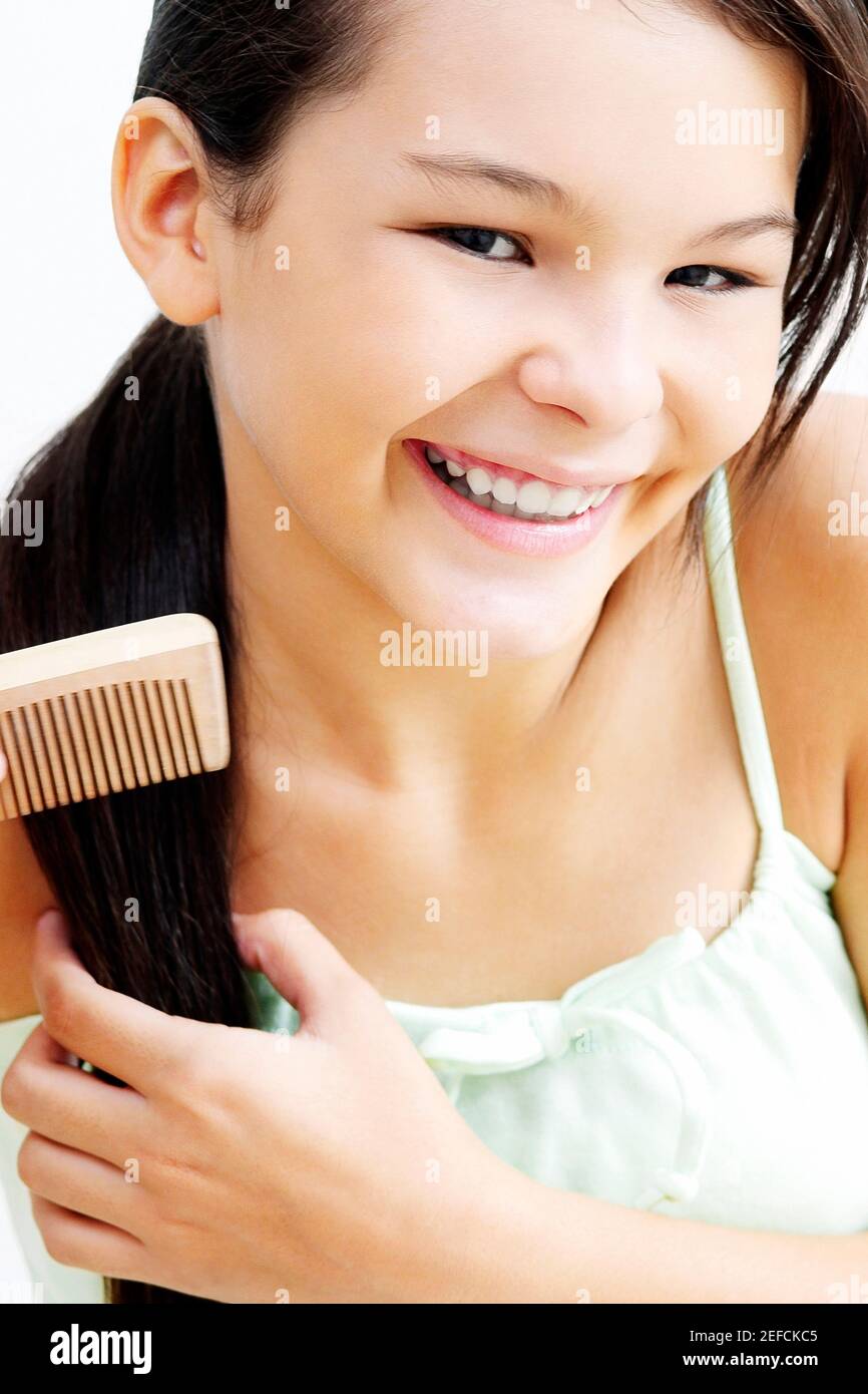 Portrait of a teenage girl combing her hair Stock Photo Alamy