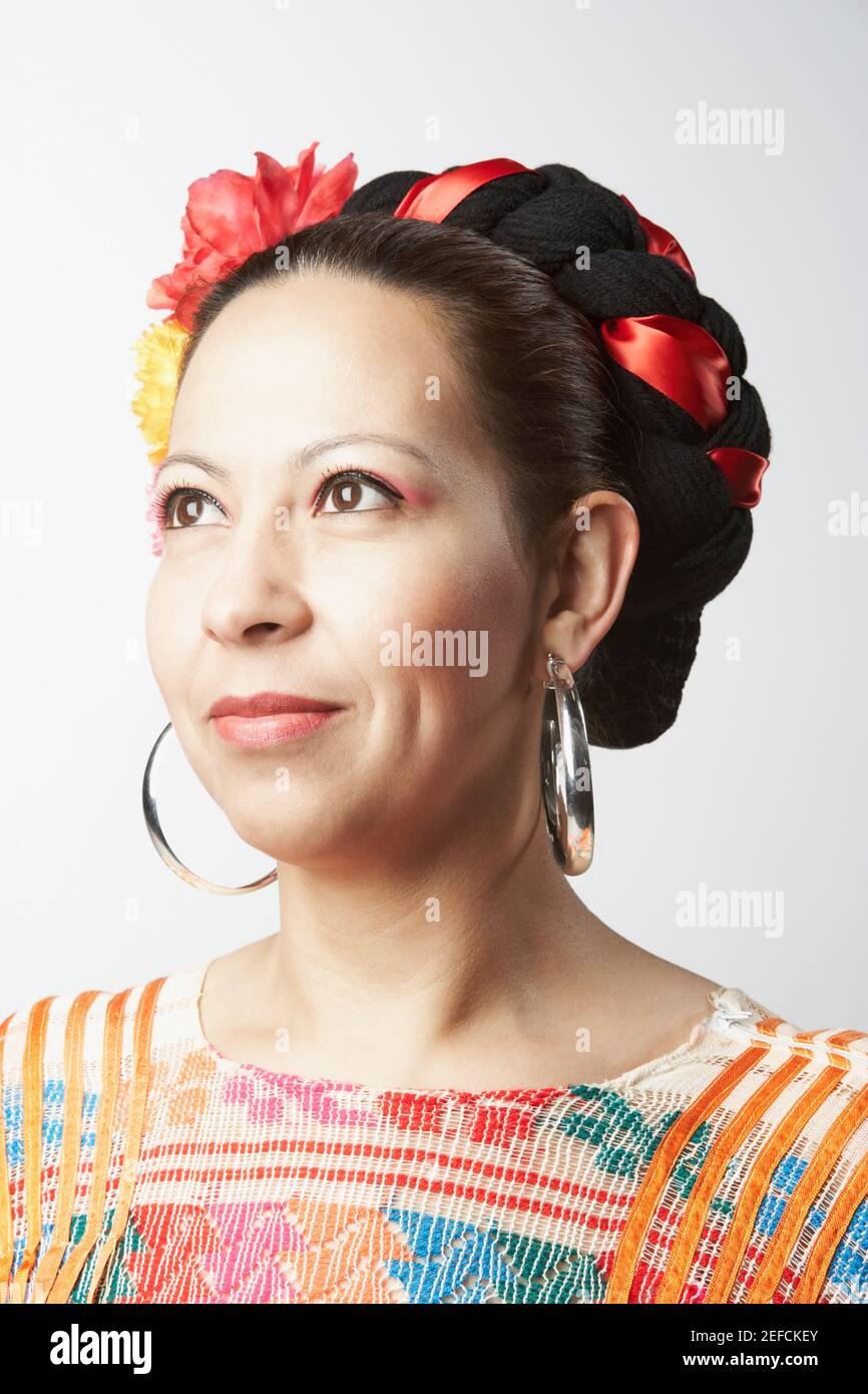 Close-up of a mid adult woman looking up and smirking Stock Photo