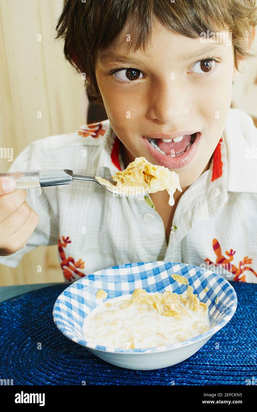 Close up of a boy eating corn flakes Stock Photo Alamy