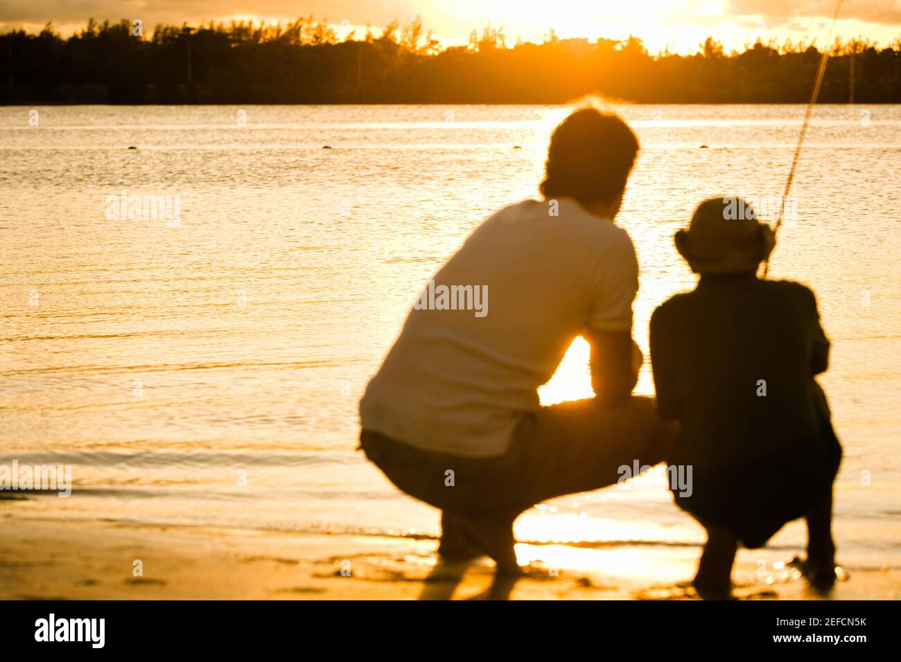 Father son silhouette fishing sunset hi-res stock photography and ...