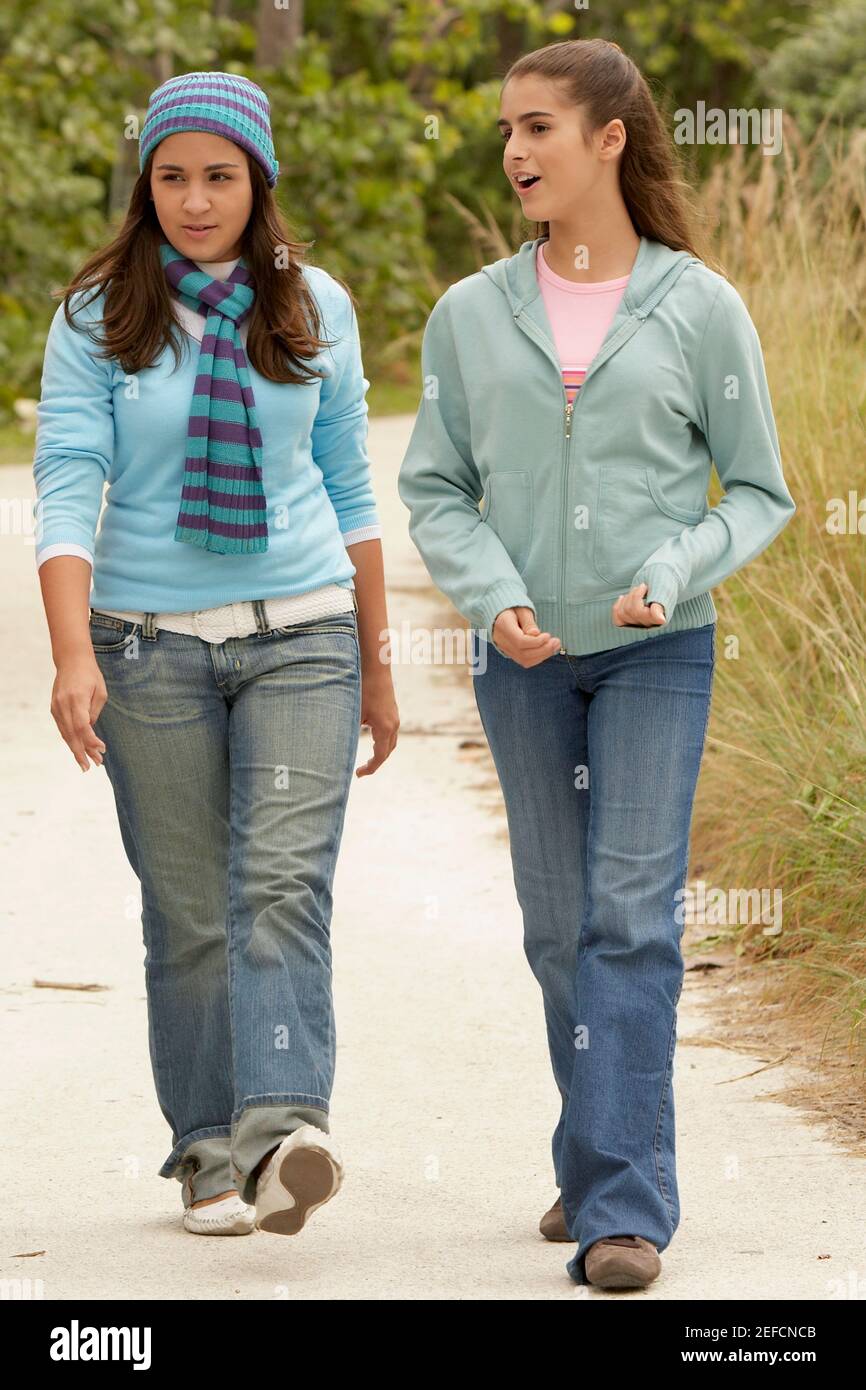 Teenage girl walking with a girl and talking Stock Photo