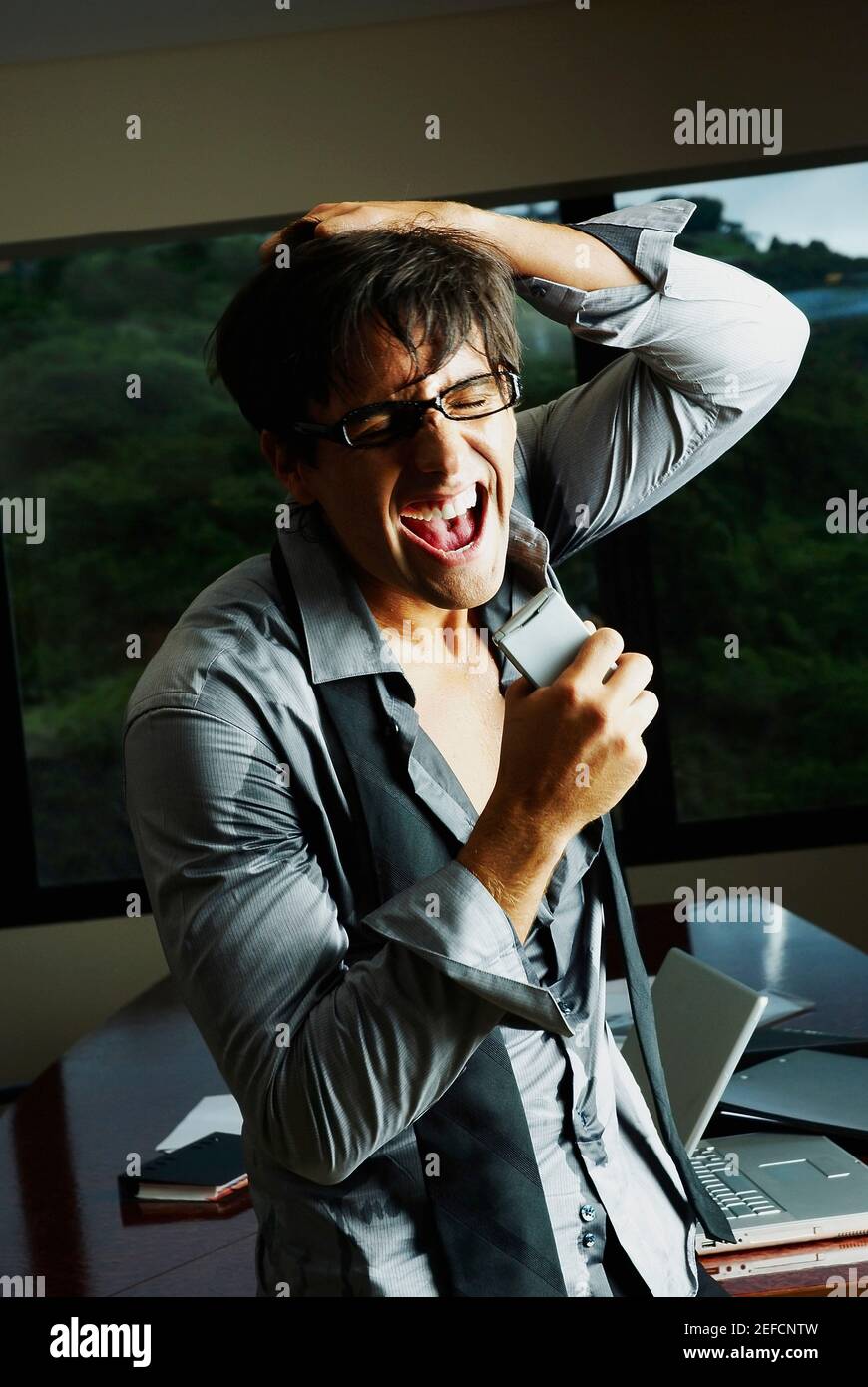 Businessman pulling his hair and screaming Stock Photo
