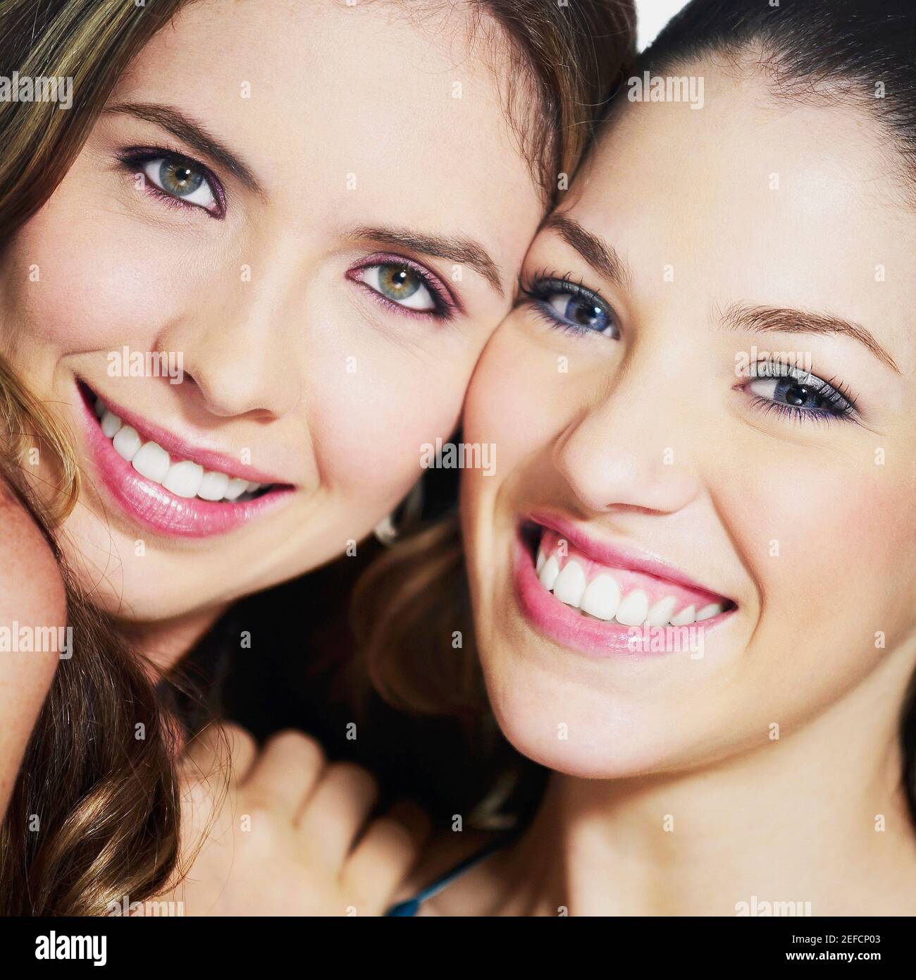 Portrait of two young women smiling Stock Photo - Alamy