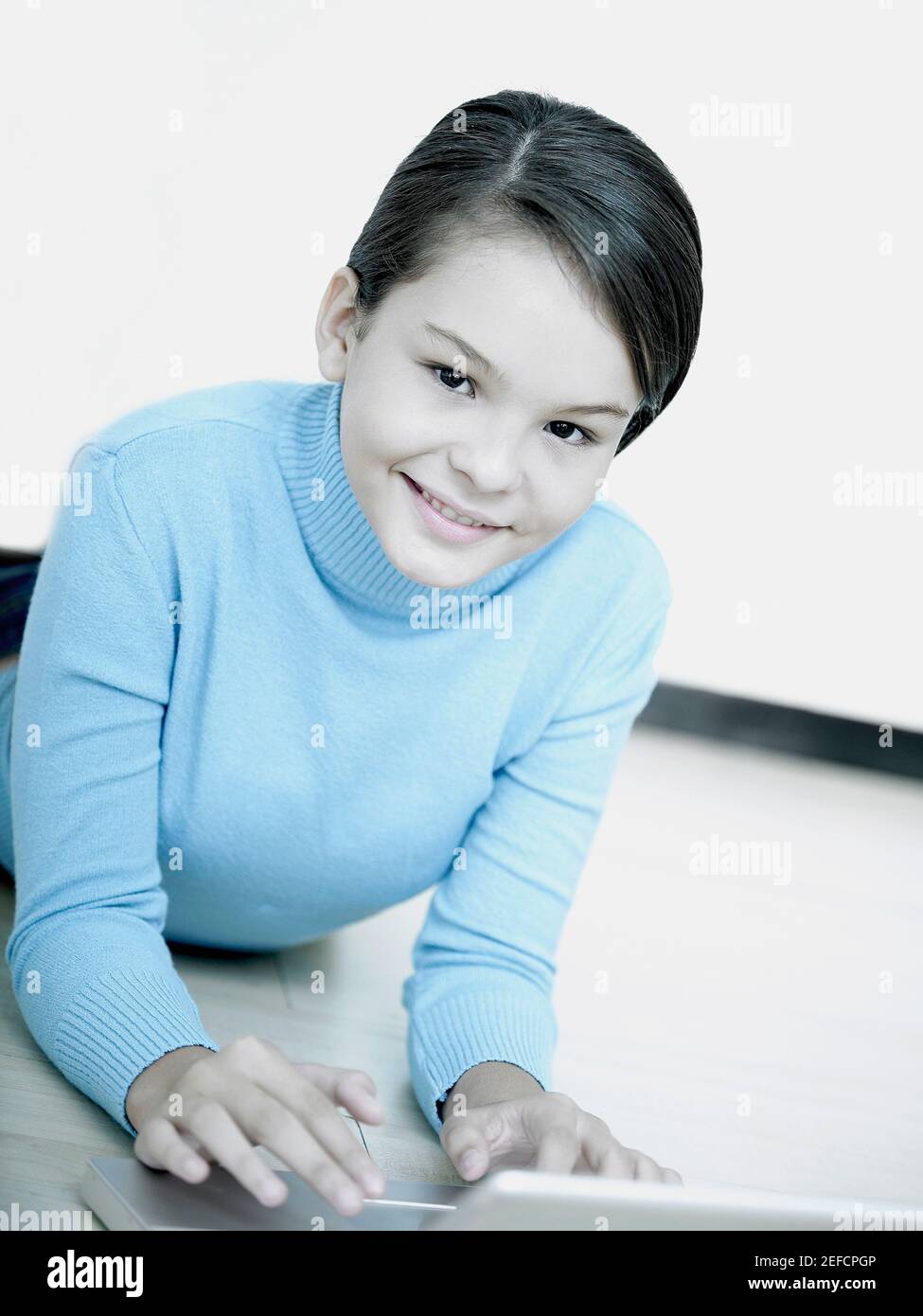 Portrait of a girl lying on the floor and using a laptop Stock Photo ...