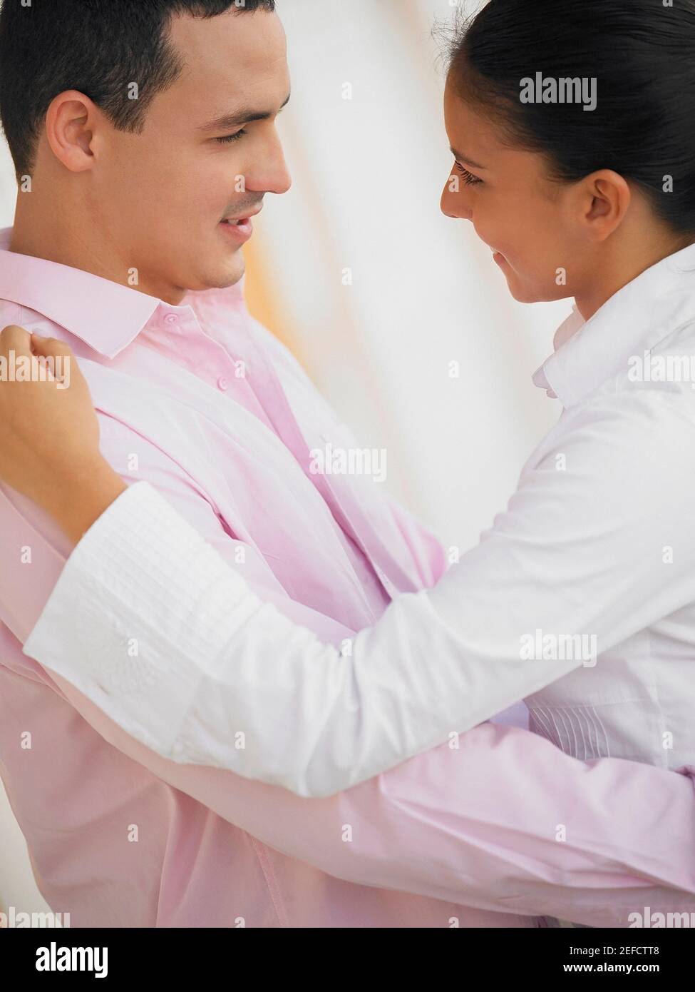 Side profile of a young man and a teenage girl looking at each other ...