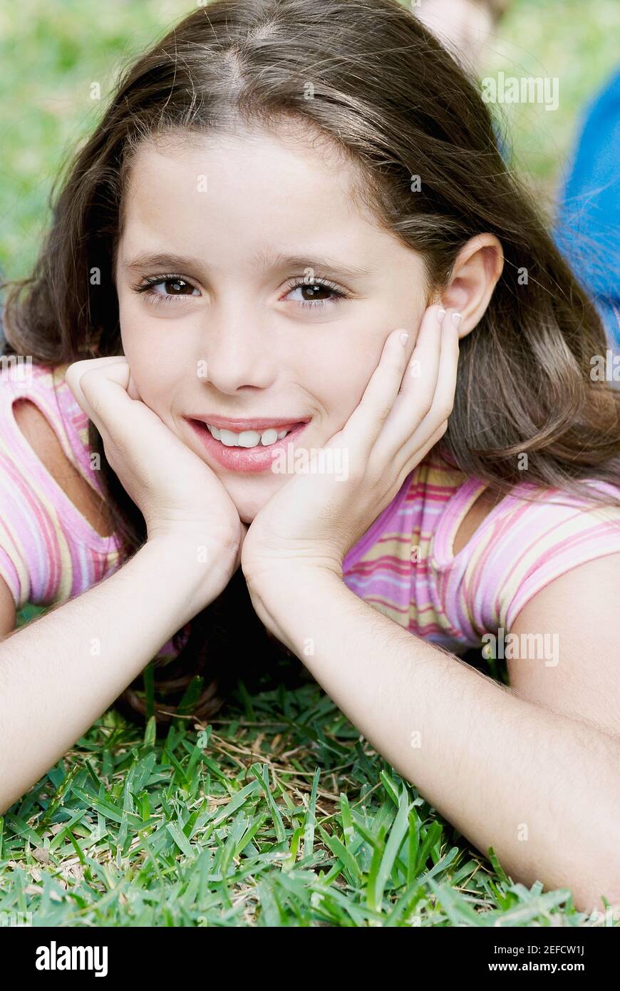 Close up of a girl lying on the grass and smiling Stock Photo - Alamy