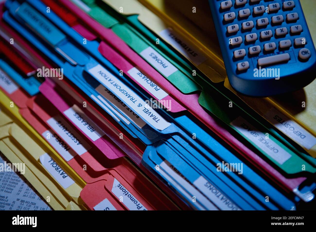 Close up of a remote control on a stack of files Stock Photo - Alamy