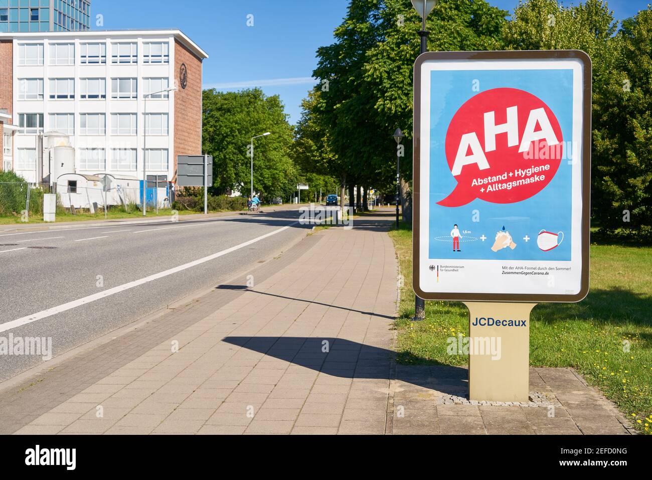 WARNEMUENDE, Germany, July 2020: Billdboard with German AHA (Abstand, Hygiene, Alltagsmaske) rules (meaning distancing, hygiene, face mask) against sp Stock Photo