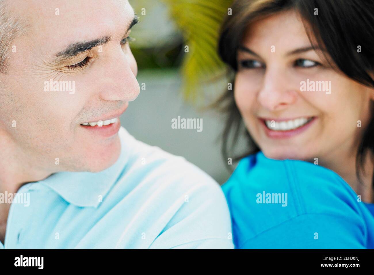 Close up of a mature couple sitting back to back Stock Photo