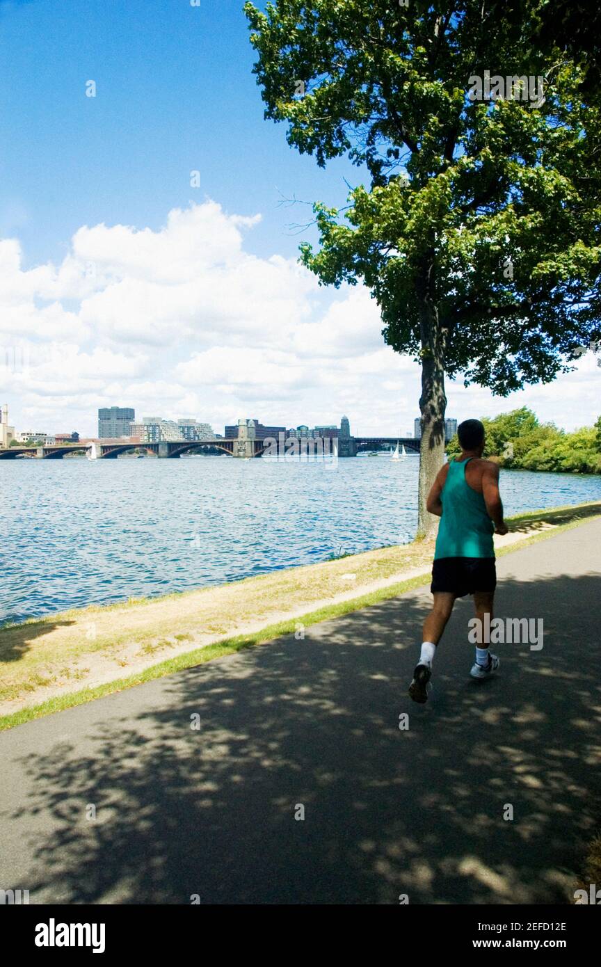 Man jogging on the bank of a river, Charles River, Longfellow Bridge, Boston, Massachusetts, USA Stock Photo