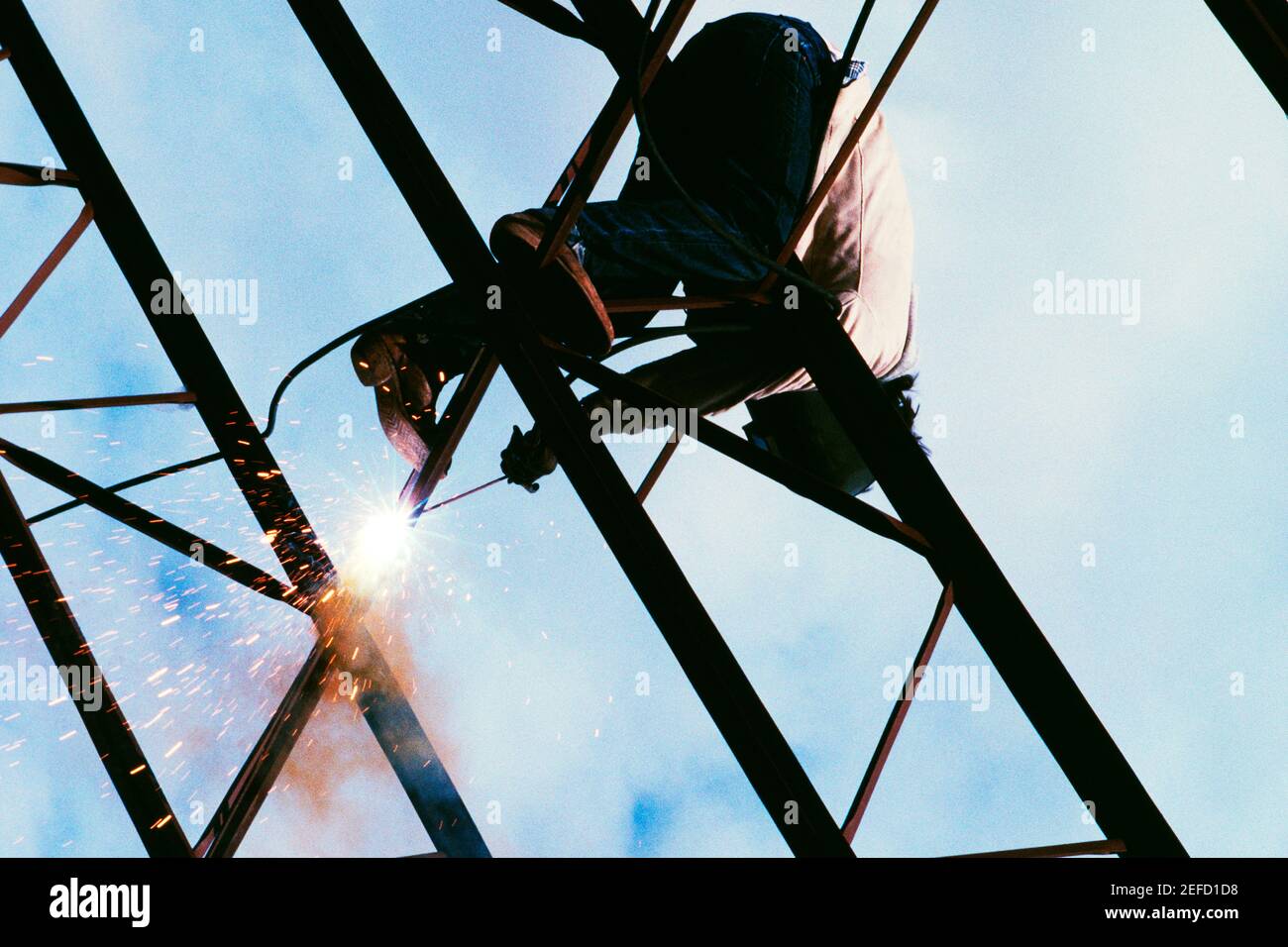 Low angle view of a welder on a metal structure Stock Photo
