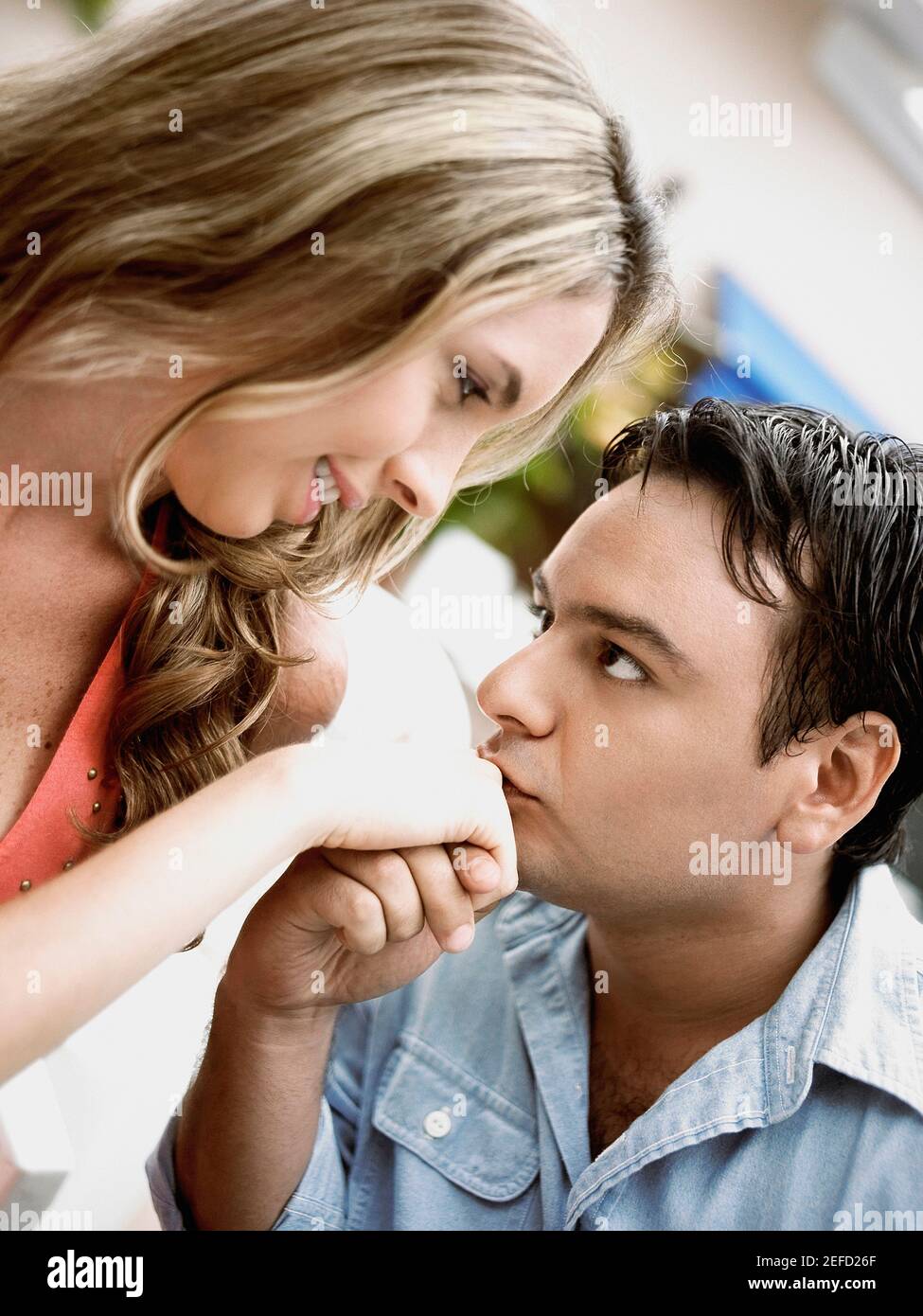 Close up of a young man kissing a young womanÅ½s hand Stock Photo - Alamy