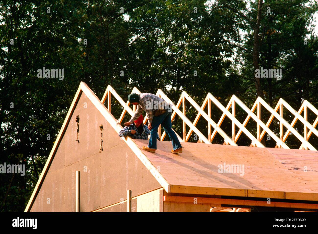 Workers putting roof on new home, Anne Arundel County, Maryland Stock