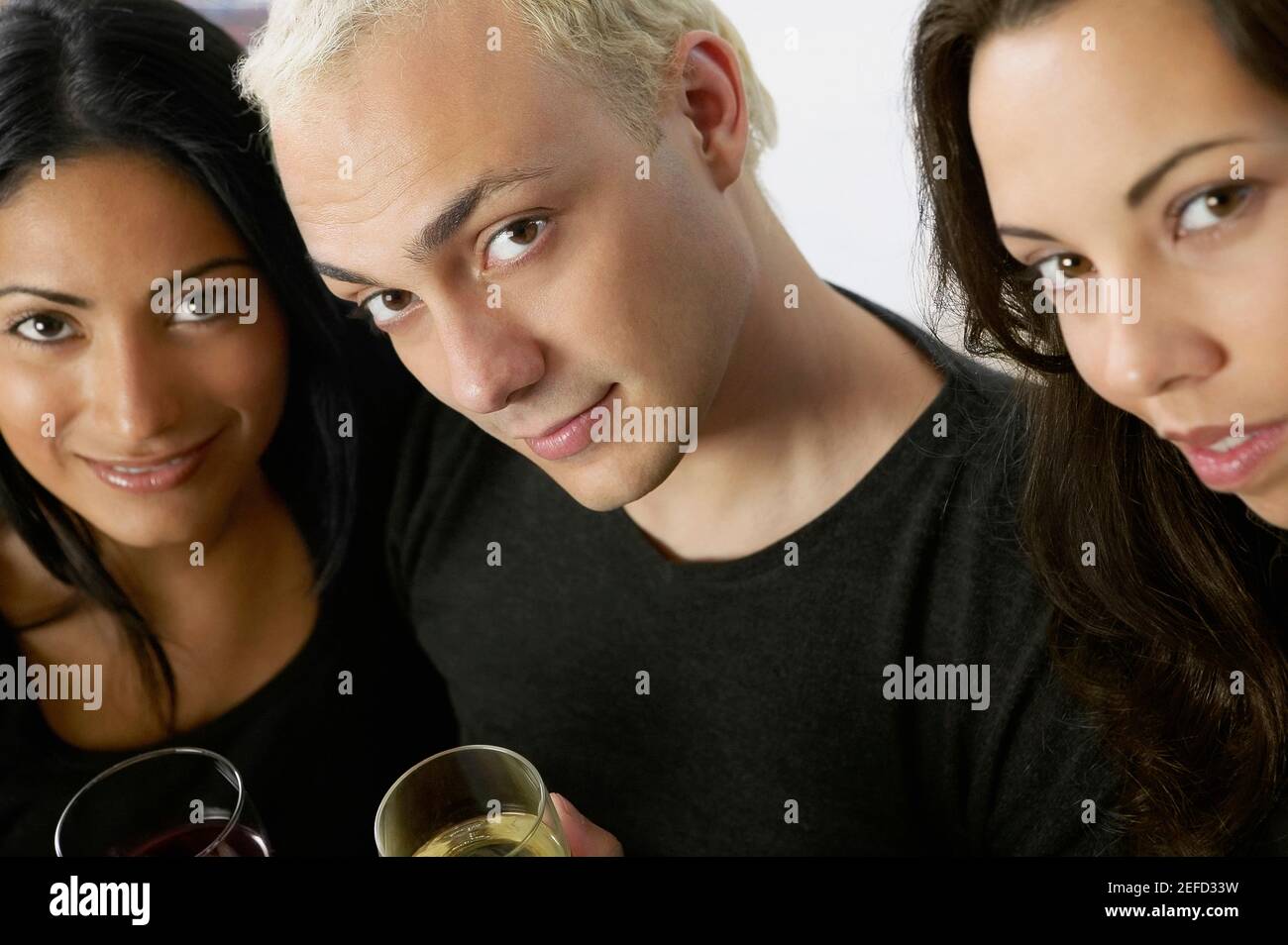 Portrait of two young women and a young man Stock Photo - Alamy