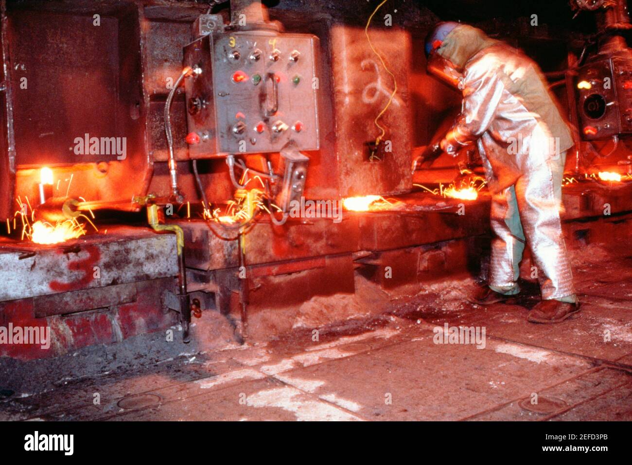 Side profile of a manual worker working in a steel plant Stock Photo Alamy
