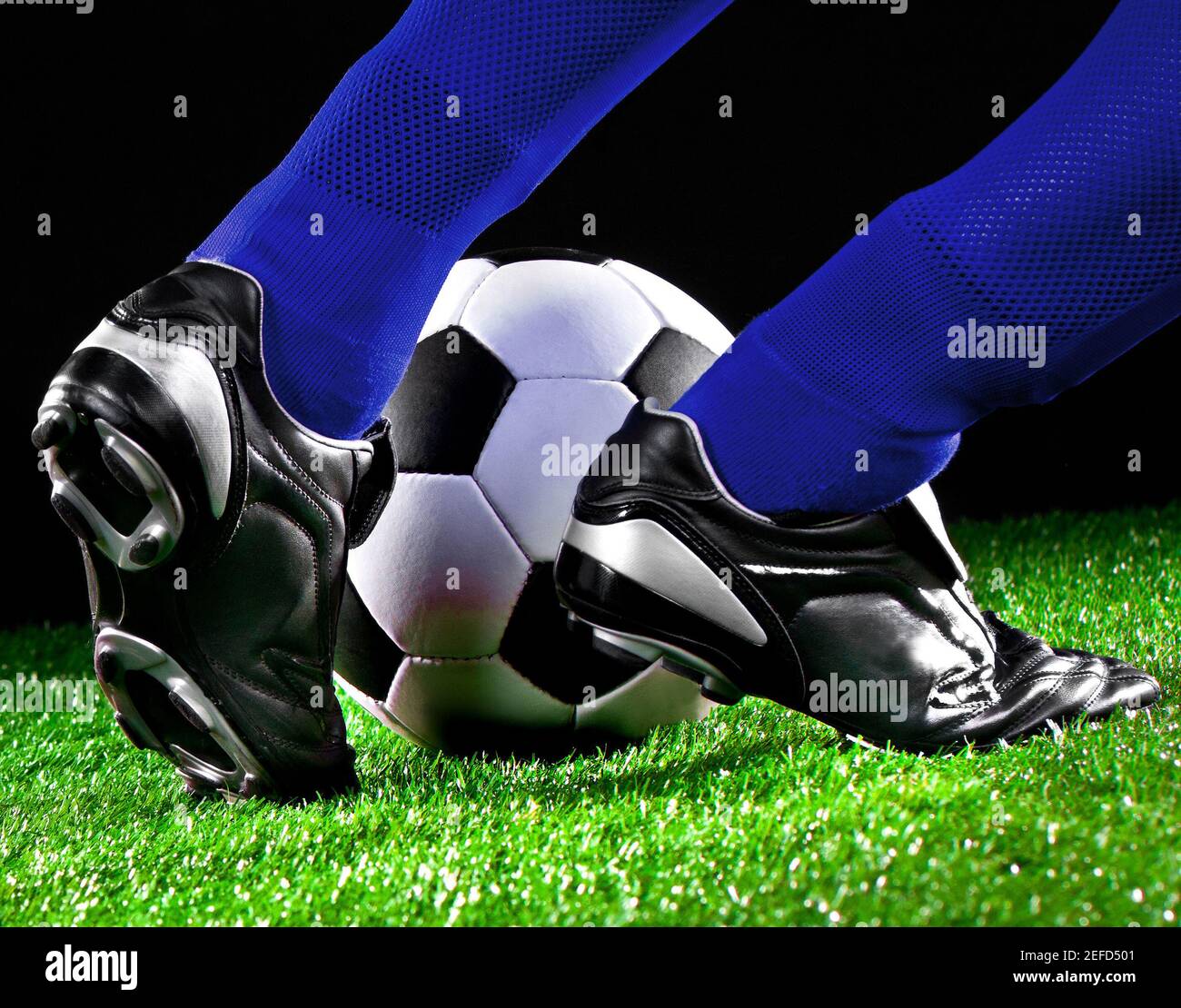 soccer ball and feet on the football field, football player in