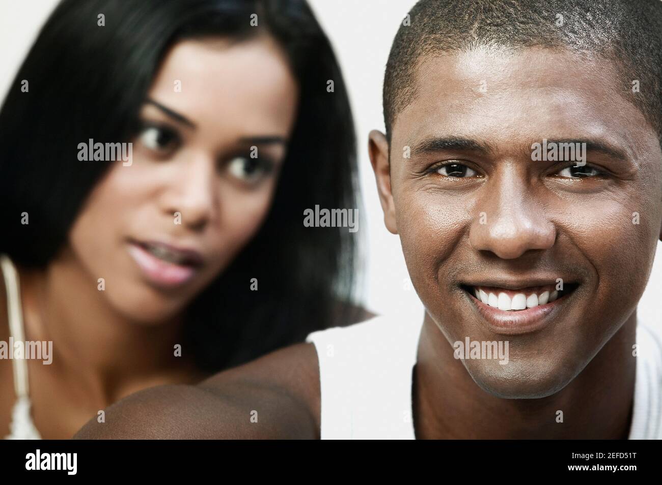 Close up of a mid adult man and a young woman smiling Stock Photo - Alamy
