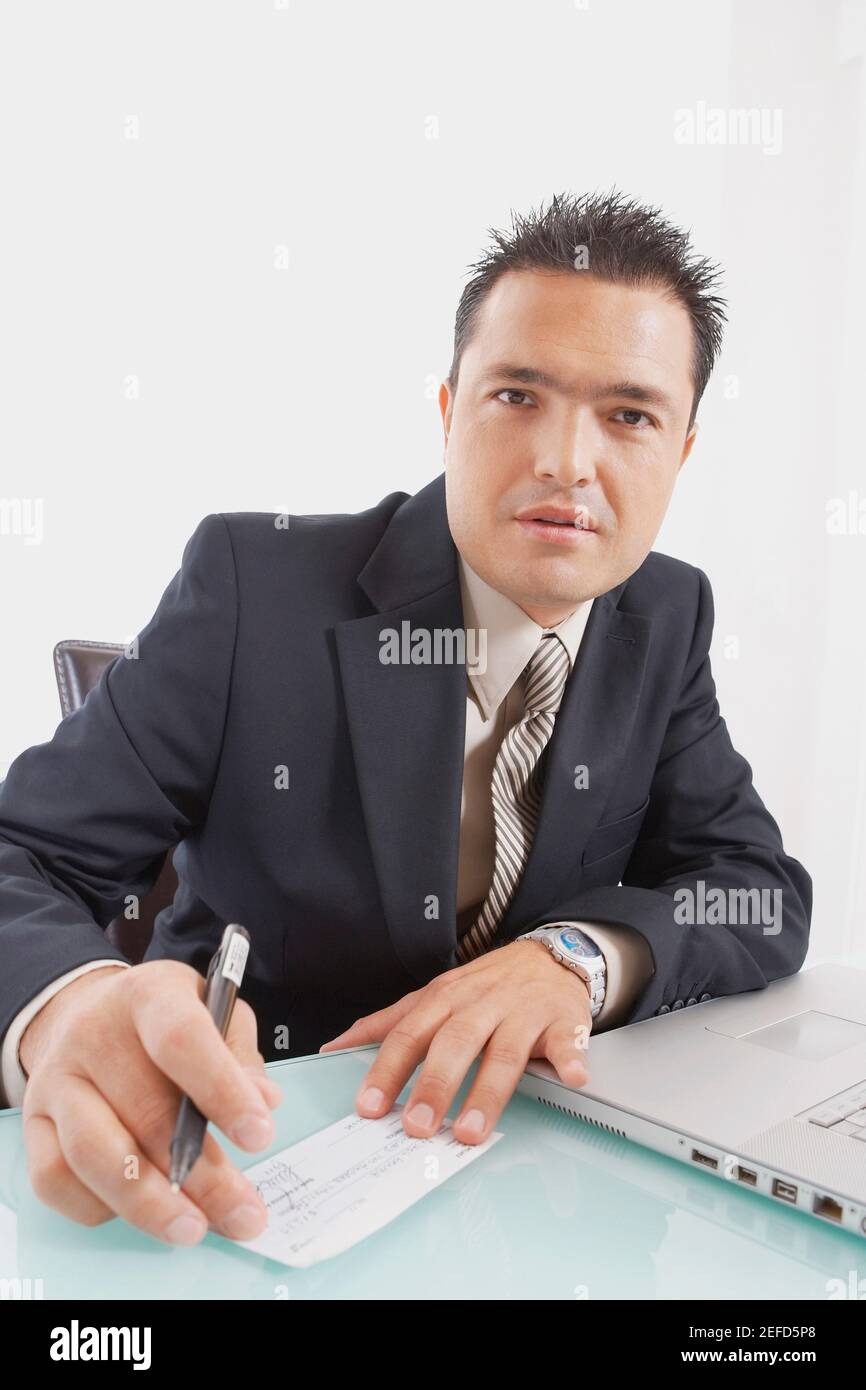 Portrait of a businessman holding a pen and a check Stock Photo - Alamy
