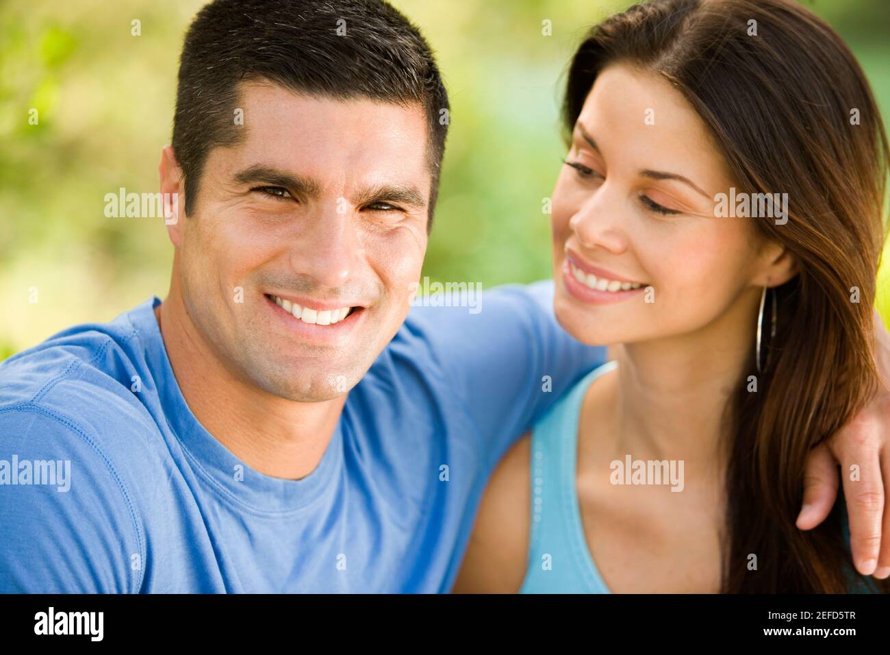 Close-up of a mid adult man and a young woman smiling Stock Photo - Alamy
