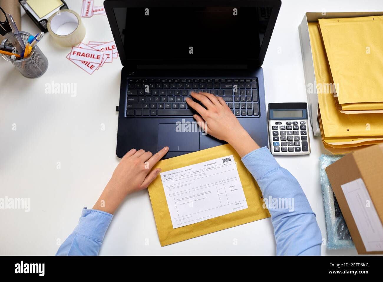 hands with laptop and envelope at post office Stock Photo Alamy