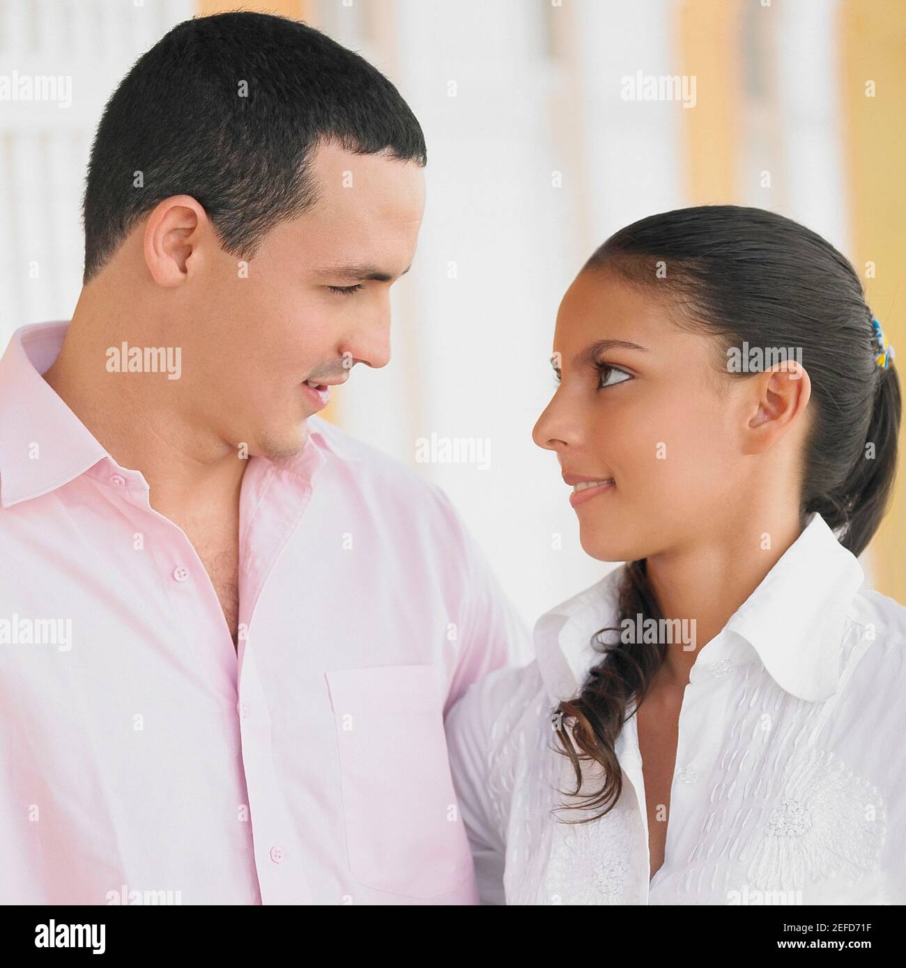 Close up of a young man and a teenage girl looking at each other Stock ...