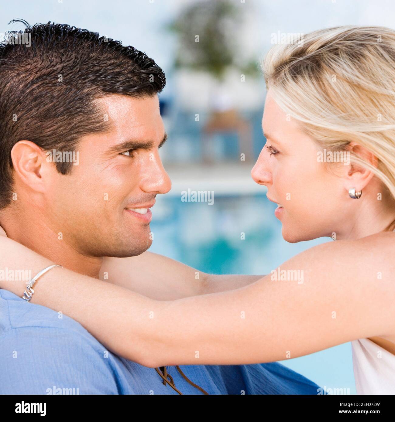Side profile of a young woman embracing a mid adult man Stock Photo - Alamy