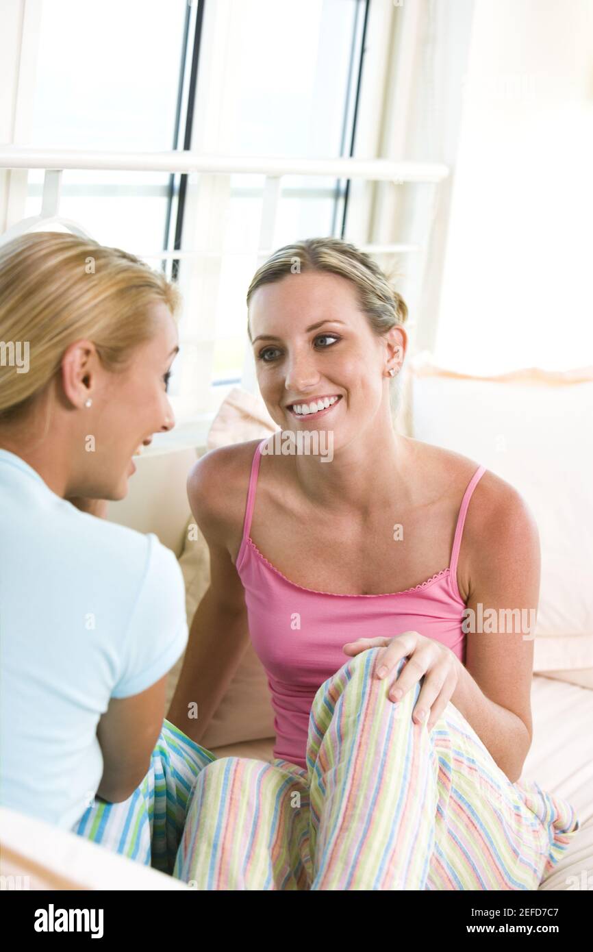 Two young women talking to each other Stock Photo