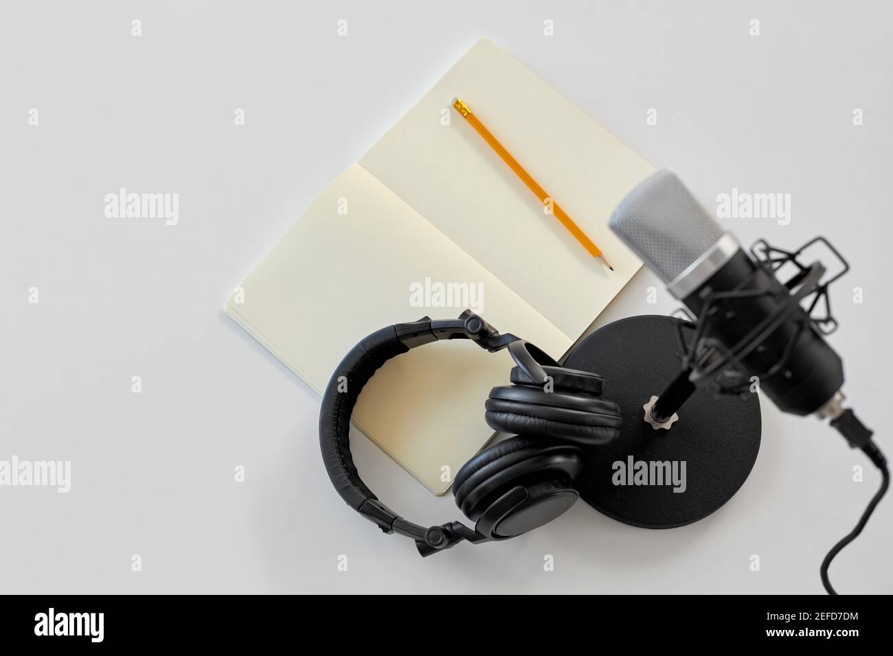 headphones, microphone and notebook with pencil Stock Photo - Alamy