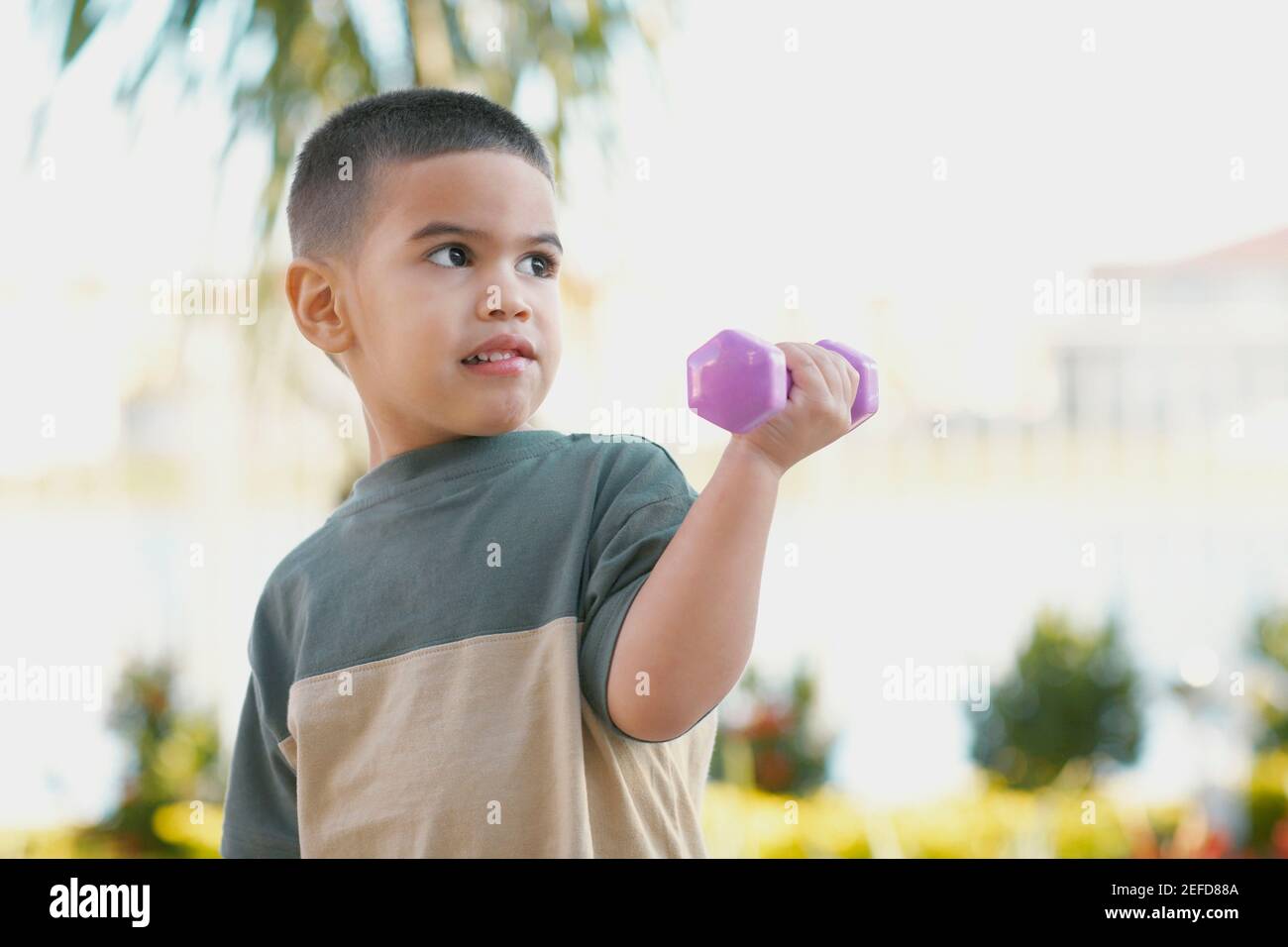 Close up of a boy exercising with dumbbells Stock Photo