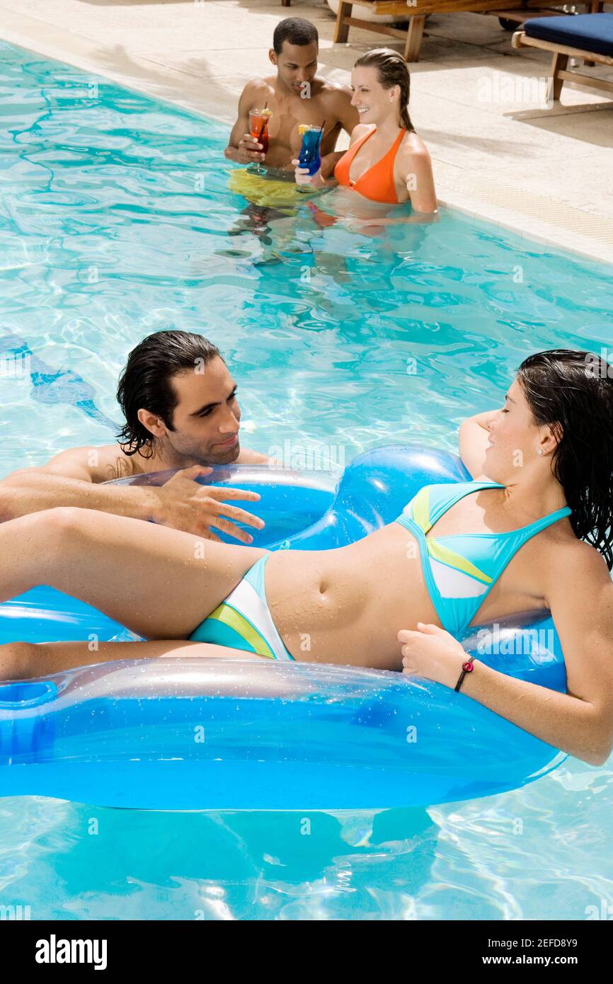 High angle view of two couples in a swimming pool Stock Photo