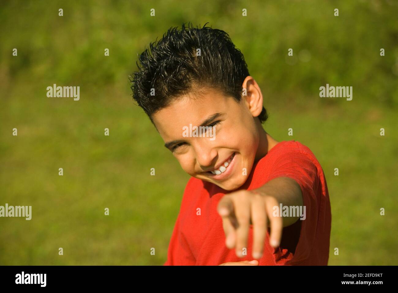 Portrait of a boy pointing forward Stock Photo