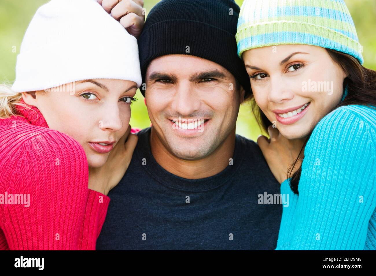Portrait of a mid adult man and two young women smiling Stock Photo