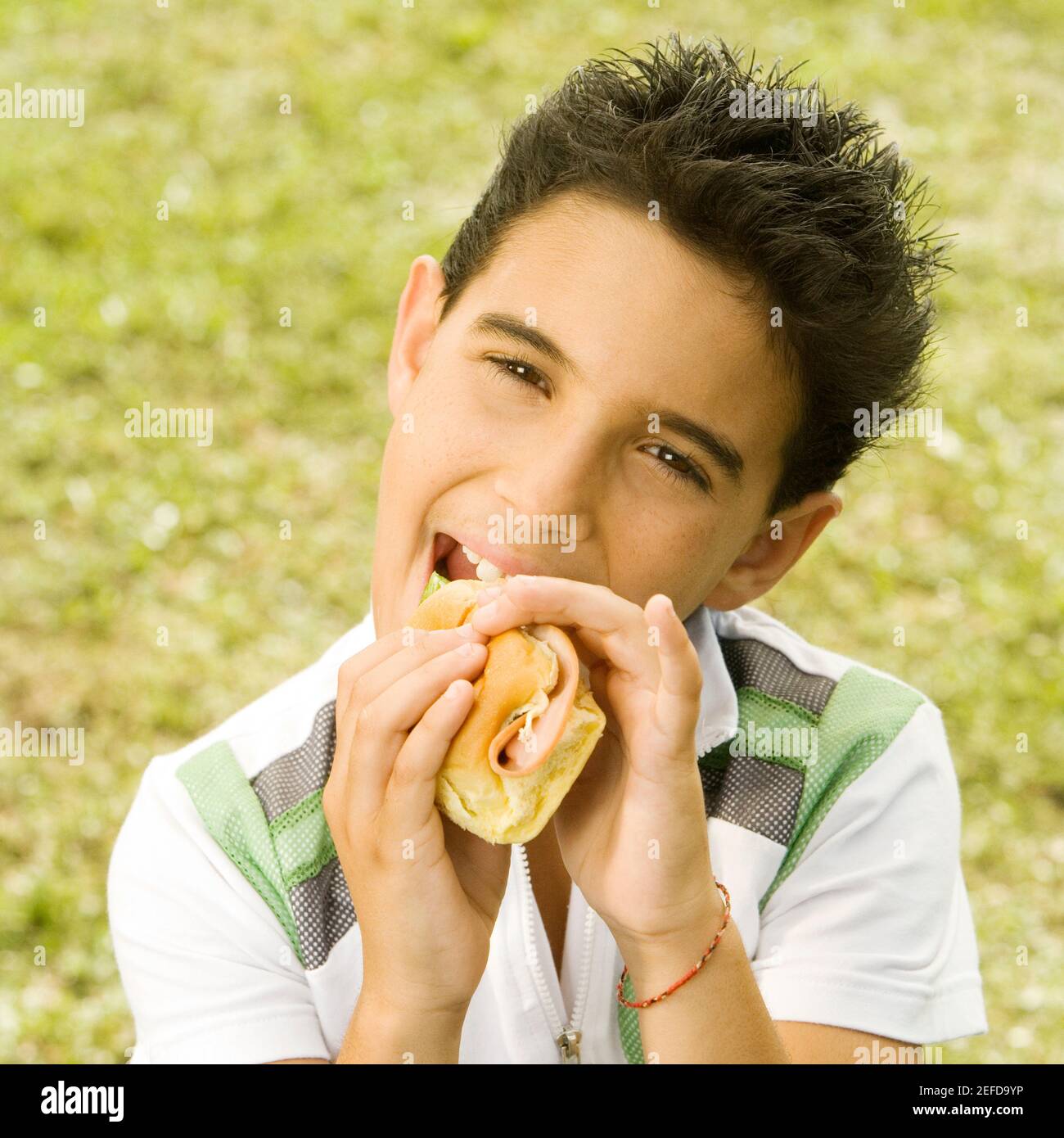 Portrait of a boy eating a burger Stock Photo