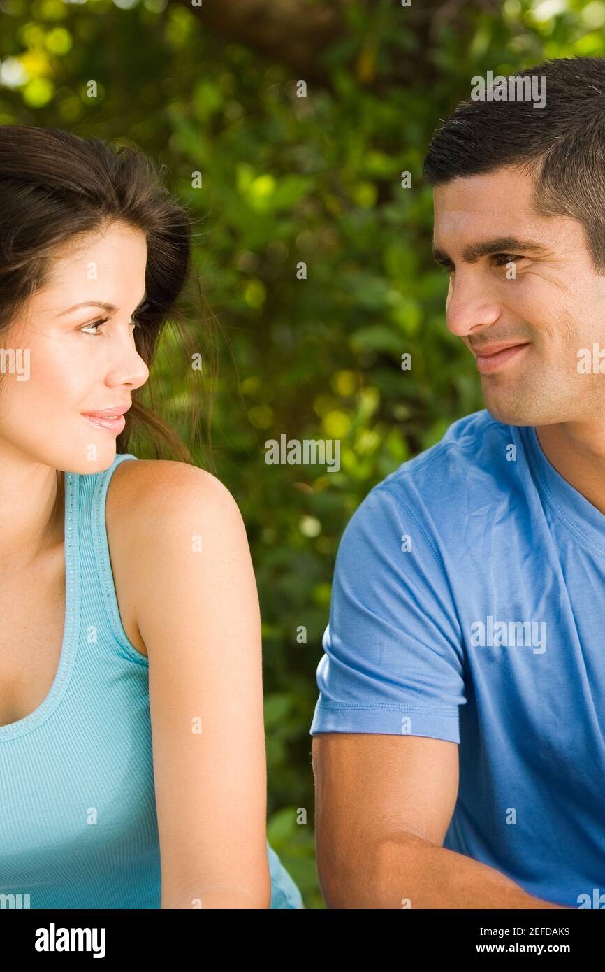 Close-up of a young woman and a mid adult man looking at each other Stock Photo