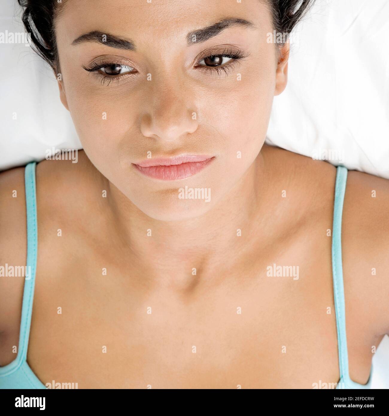 Closeup of a young woman lying on a bed Stock Photo Alamy