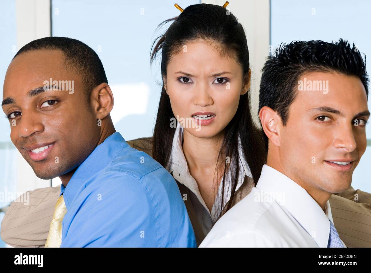 Close-up of two businessmen with a businesswoman Stock Photo