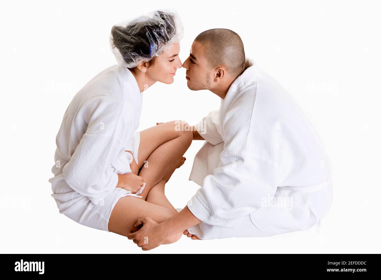 Side profile of a young couple nuzzling Stock Photo