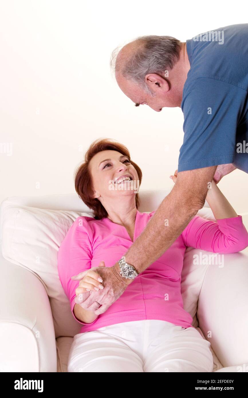 Senior couple holding hands looking at each other Stock Photo