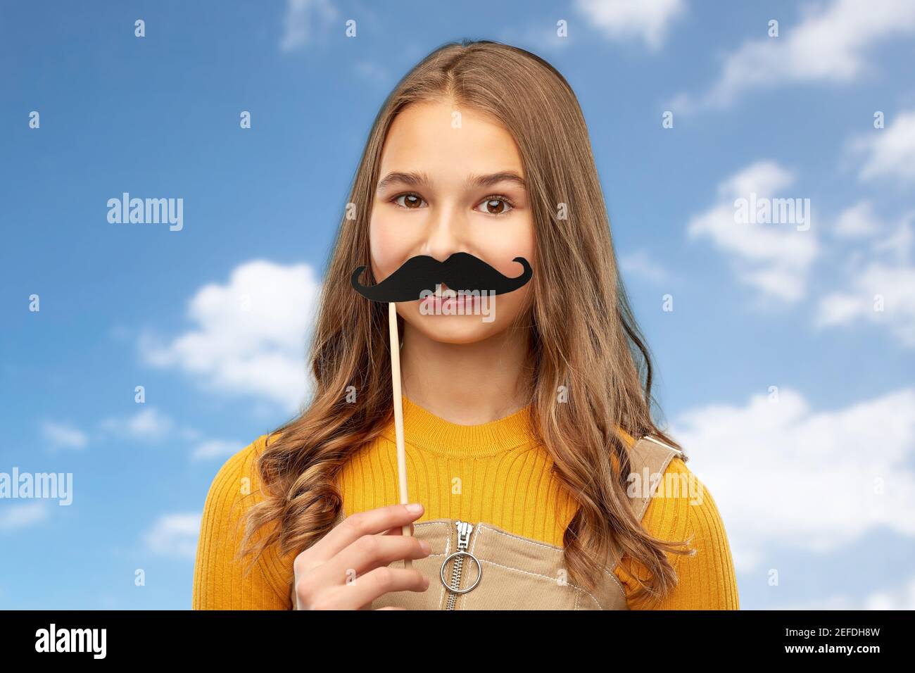 teenage girl with black moustaches party accessory Stock Photo