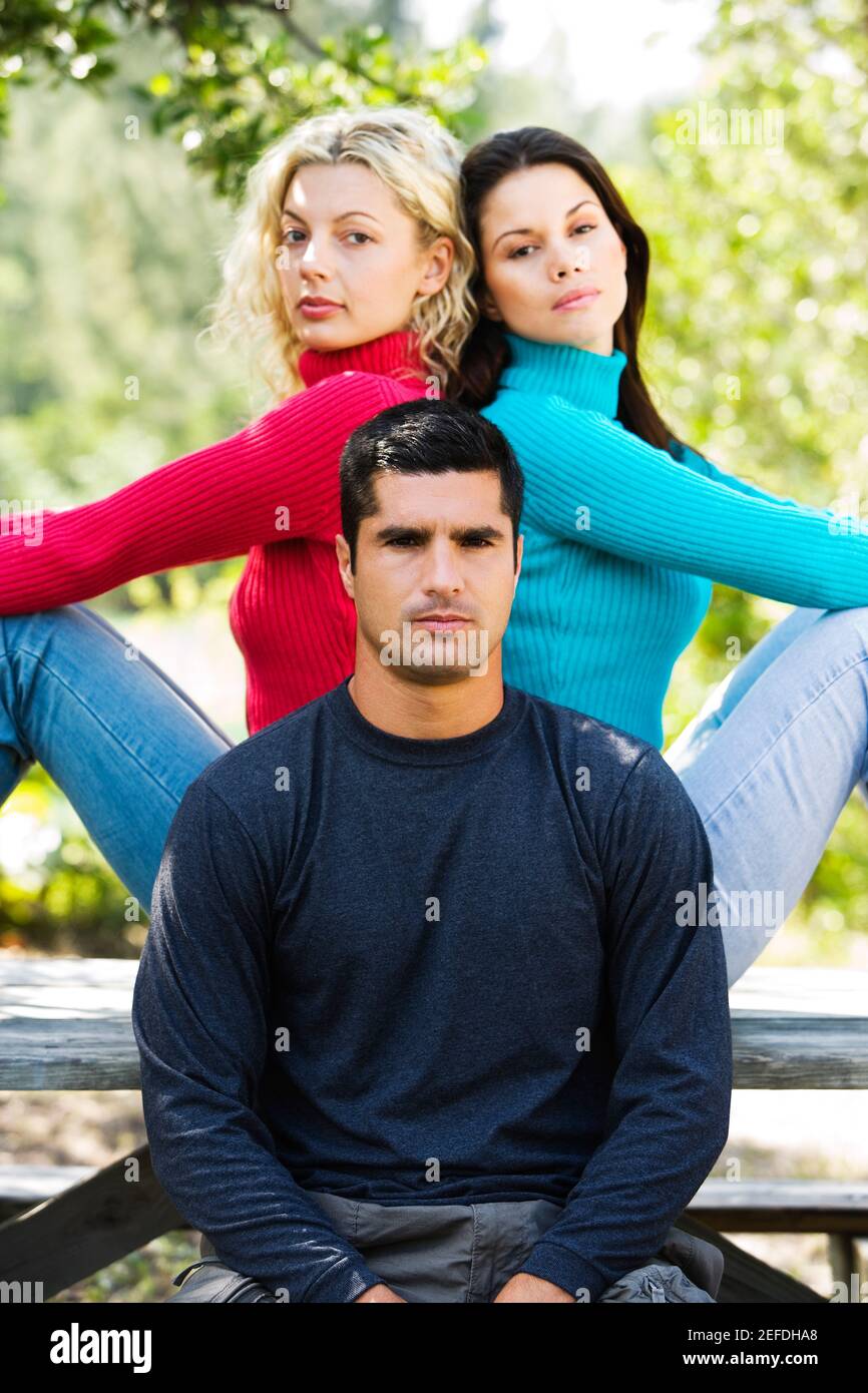 Portrait of a mid adult man and two young women Stock Photo